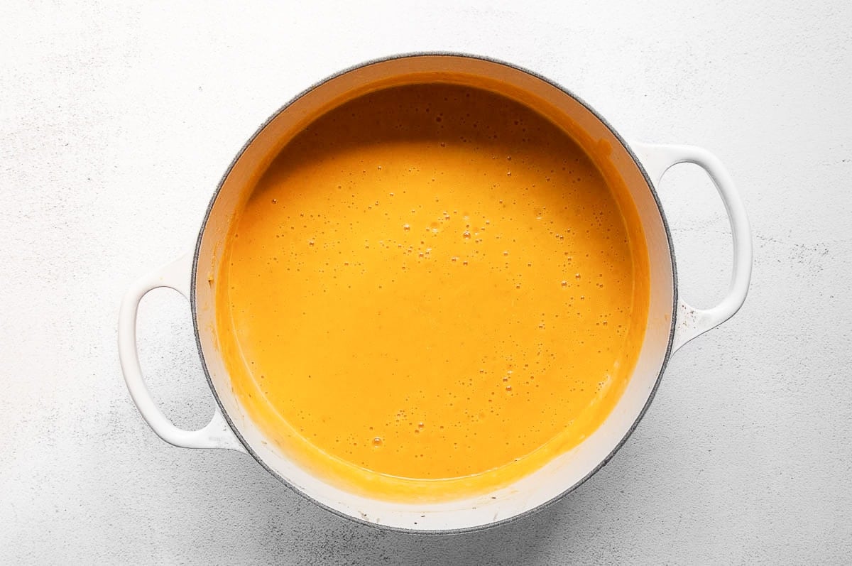 Butternut squash soup in a white pot.