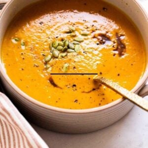 Healthy pumpkin soup in a bowl with pumpkin seed garnish.
