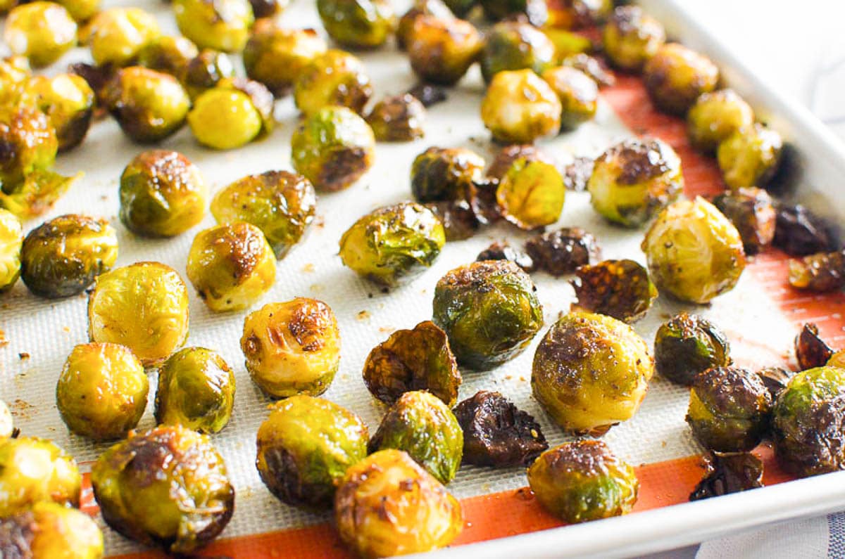 Roasted brussels sprouts on silpat lined baking sheet.