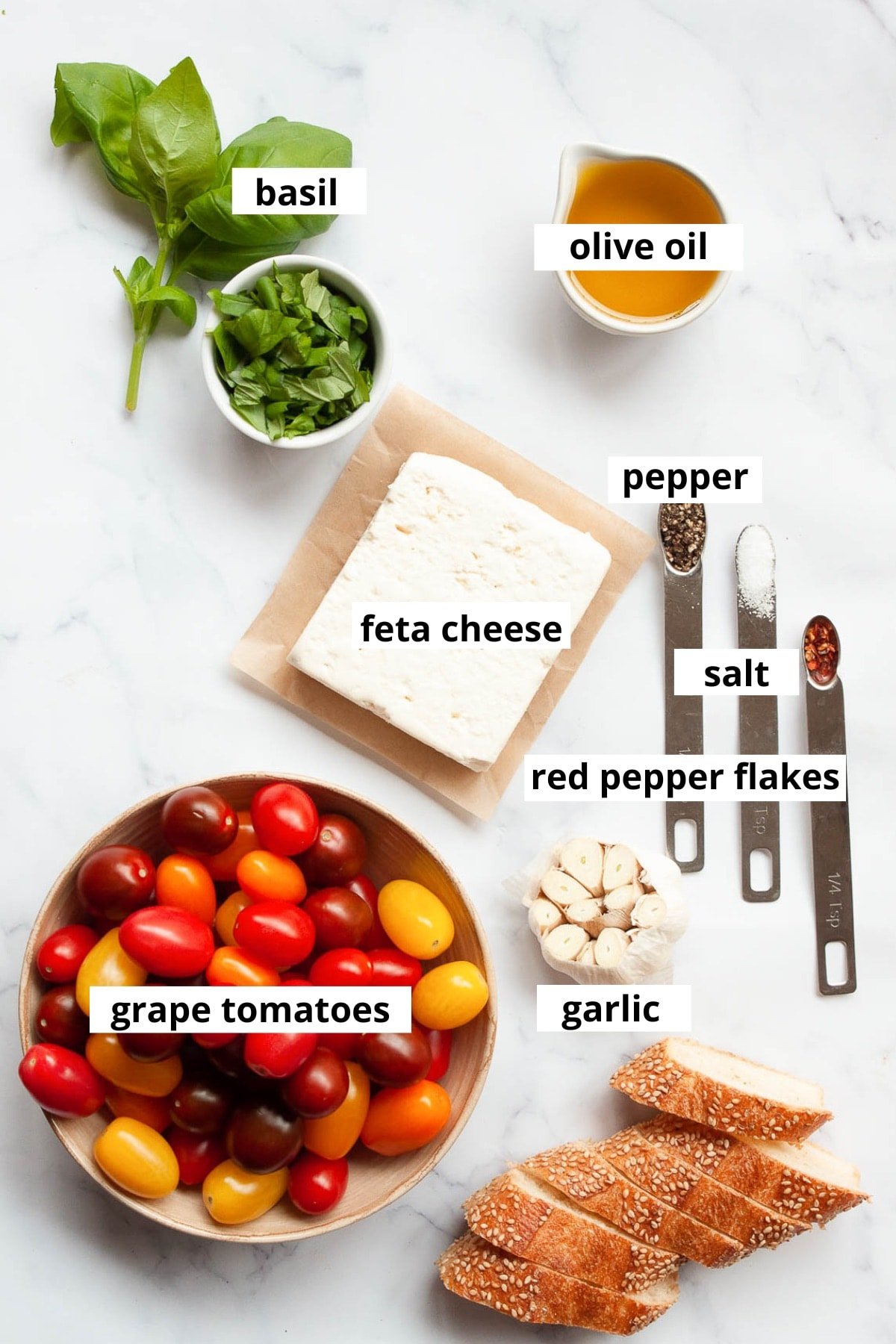 Grape tomatoes, feta cheese block, olive oil, garlic, basil, red pepper flakes, salt, pepper, baguette.