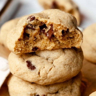 Stack of oat flour chocolate chip cookies with top one showing texture inside.
