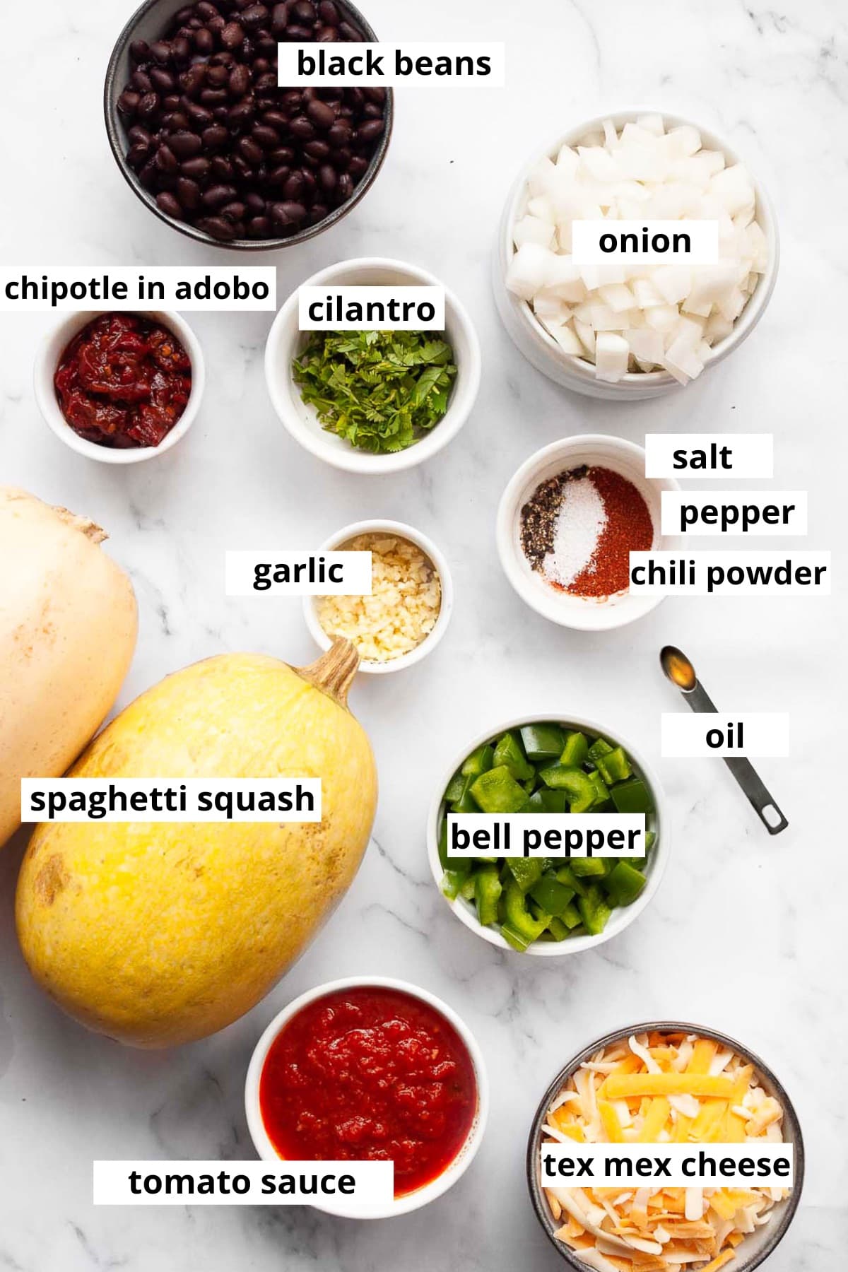 Spaghetti squash, tomato sauce, tex mex cheese, bell pepper, oil, garlic, cilantro, chipotle in adobo, onion, black beans, salt, pepper, chili powder.