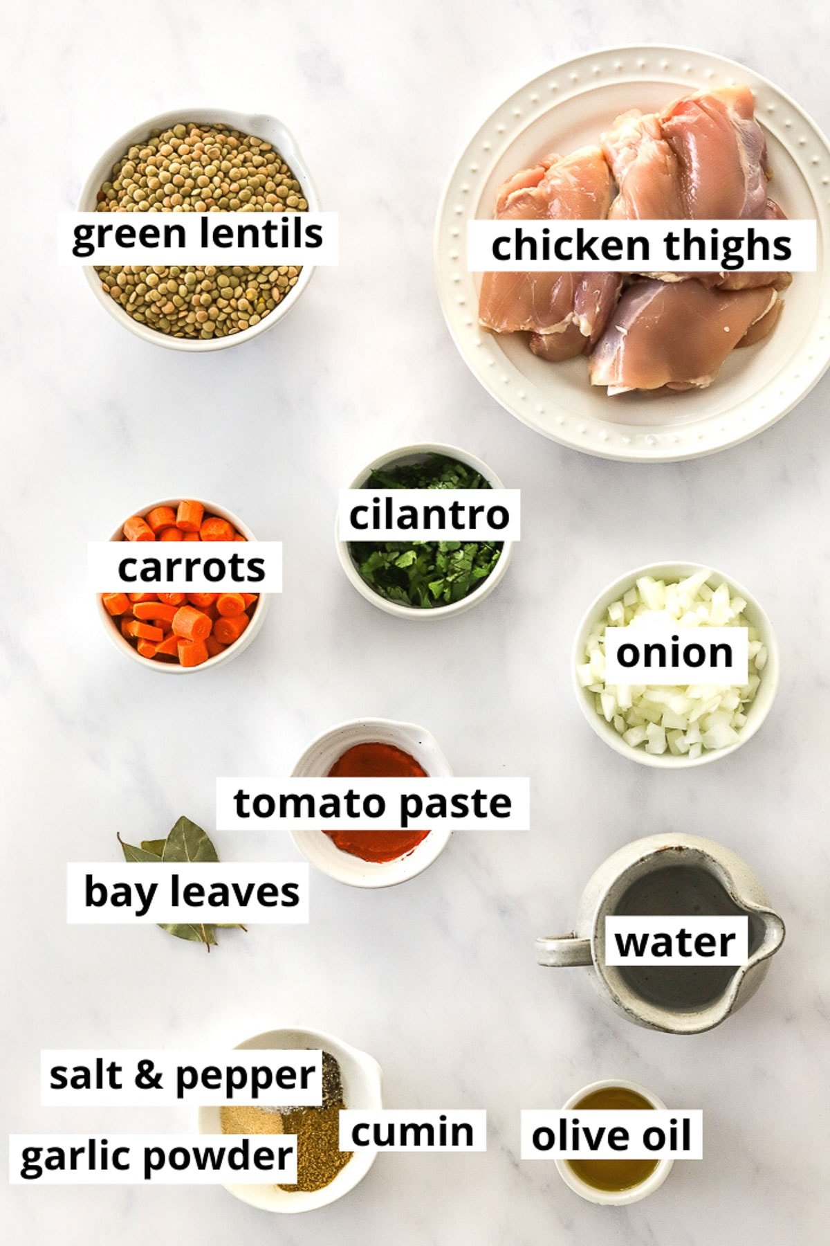 Chicken thighs, green lentils, carrots, onion, cilantro, tomato paste, bay leaves, water, oil, garlic powder, cumin, salt and pepper.