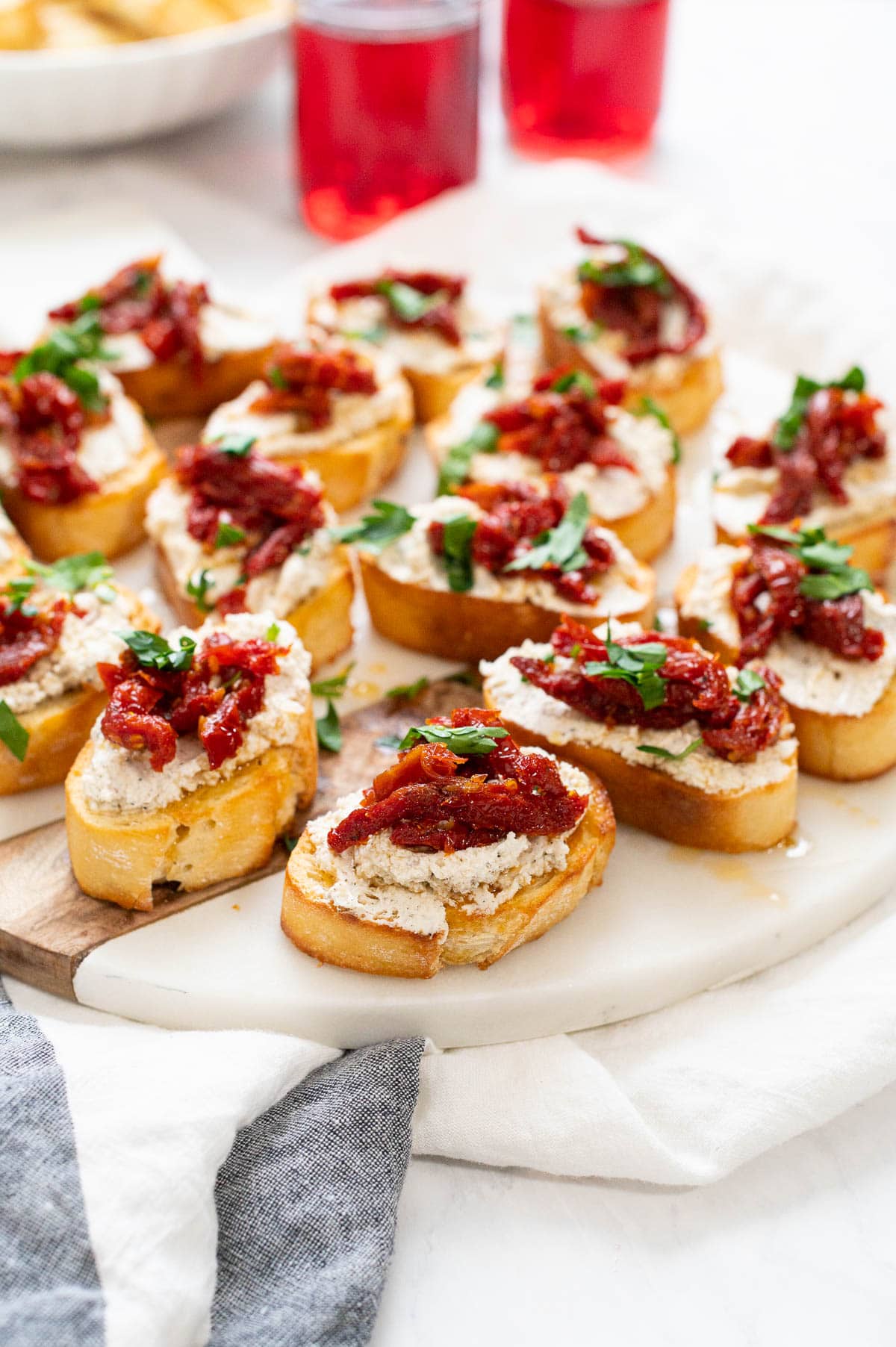 Crostinis served with sun dried tomatoes and parsley.