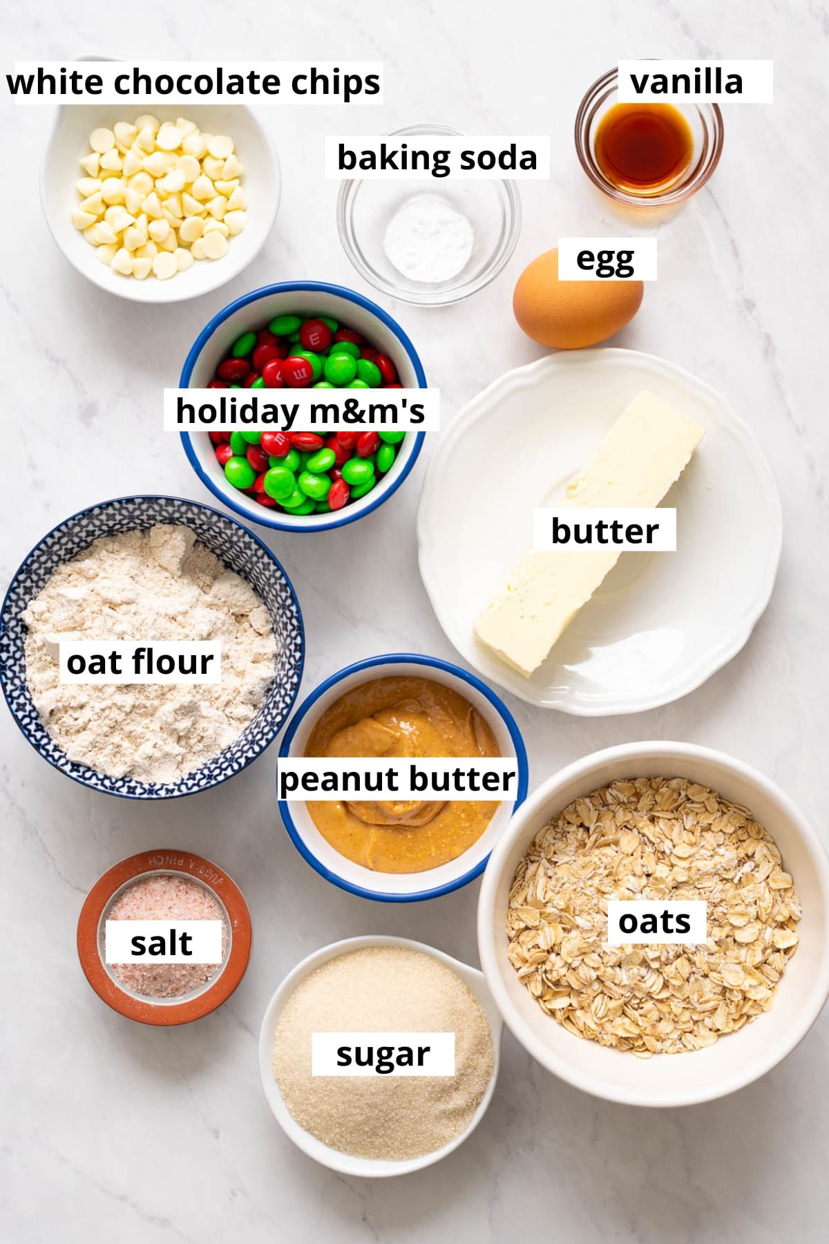 Oat flour, oats, peanut butter, sugar, butter, vanilla extract, baking soda, egg, white chocolate chips, holiday m&m's, salt.