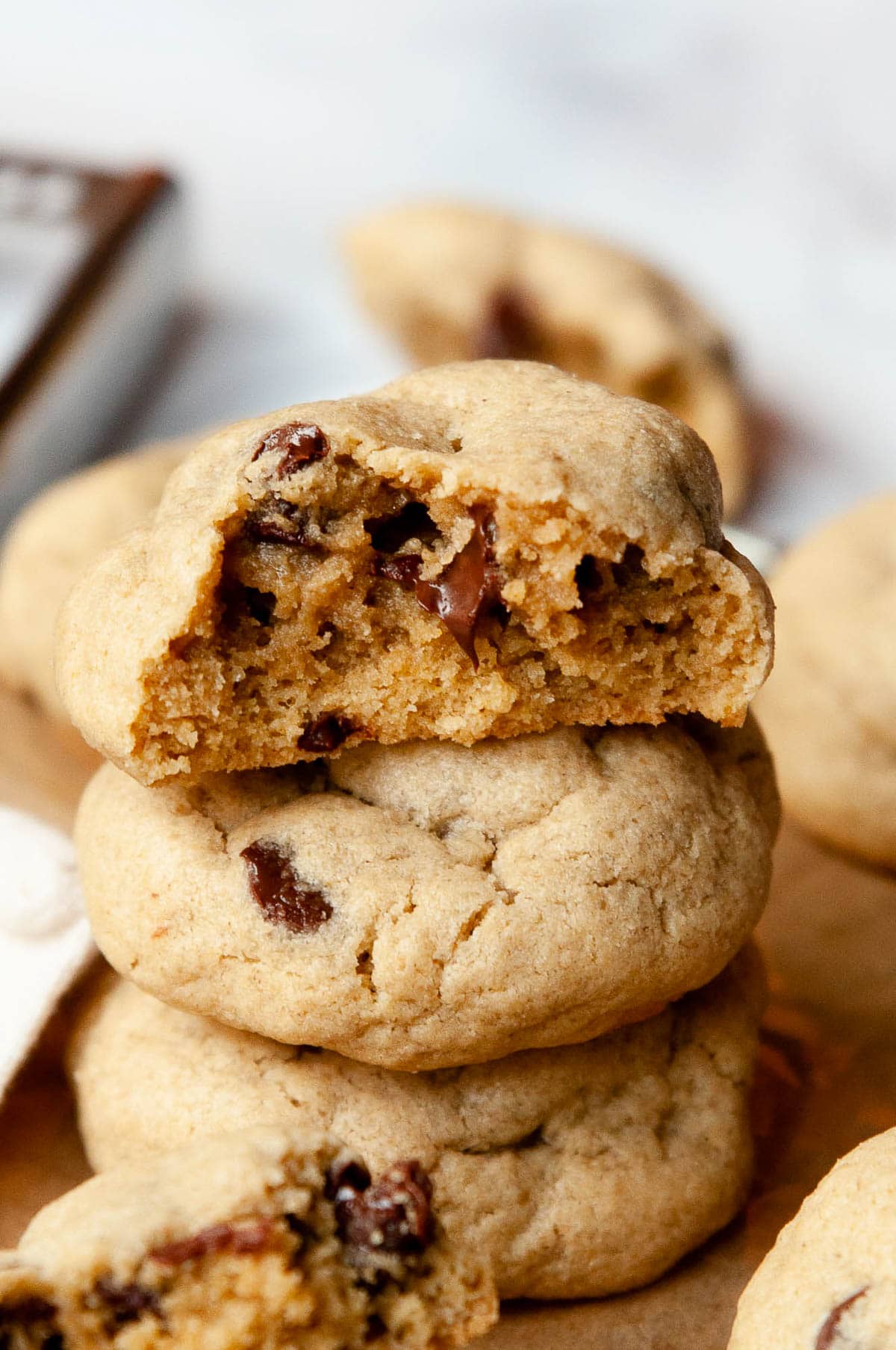 Stack of oat flour chocolate chip cookies with top one showing texture inside.