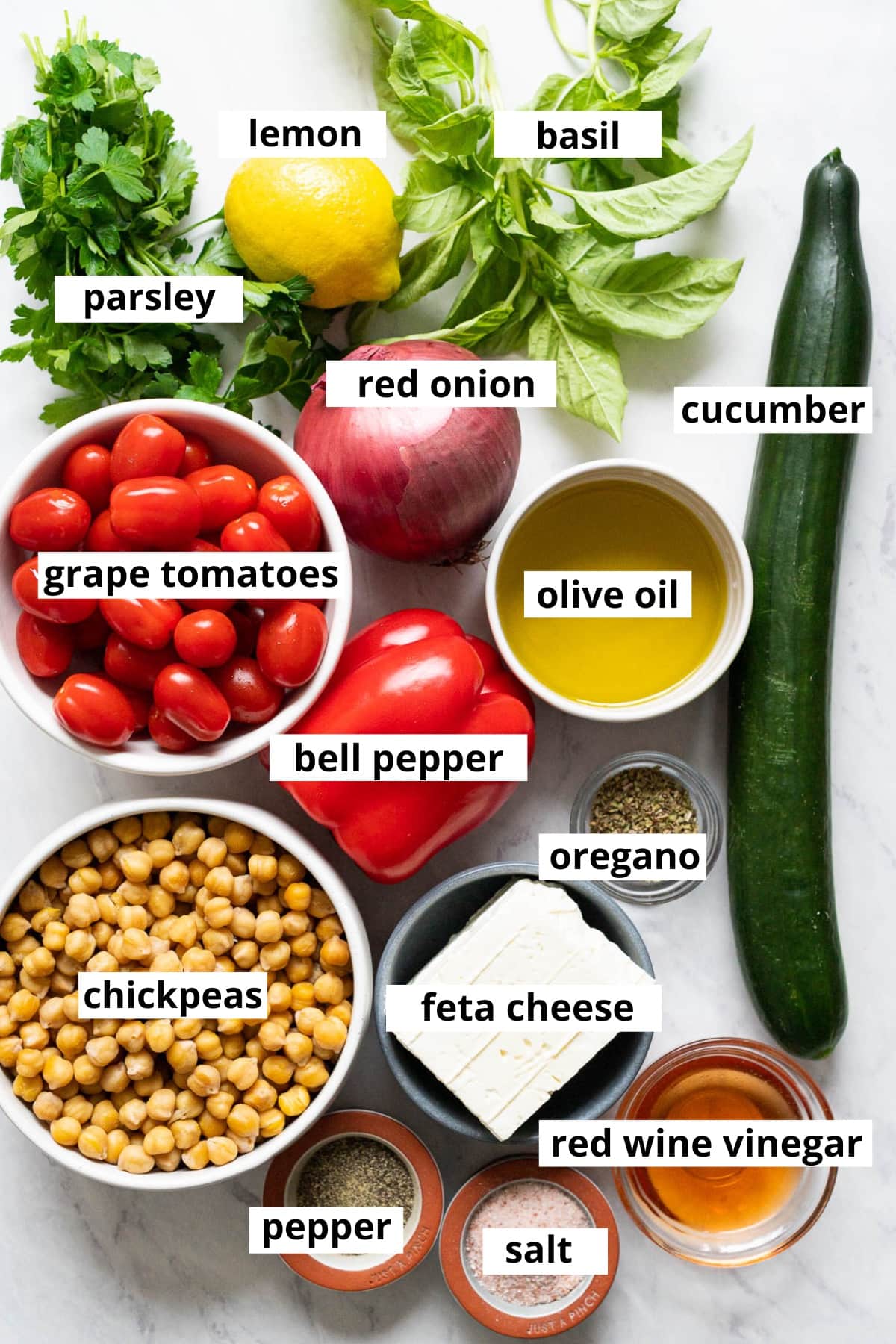 Chickpeas, feta cheese, red wine vinegar, salt, pepper, oregano, cucumber, bell pepper, olive oil, grape tomatoes, red onion, parsley, lemon, basil.