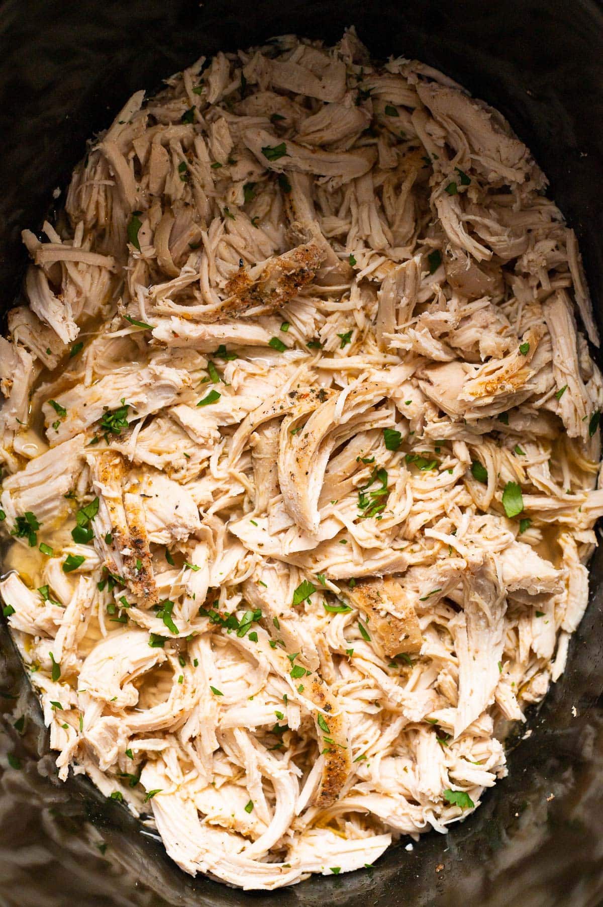 Closeup of crockpot shredded chicken.