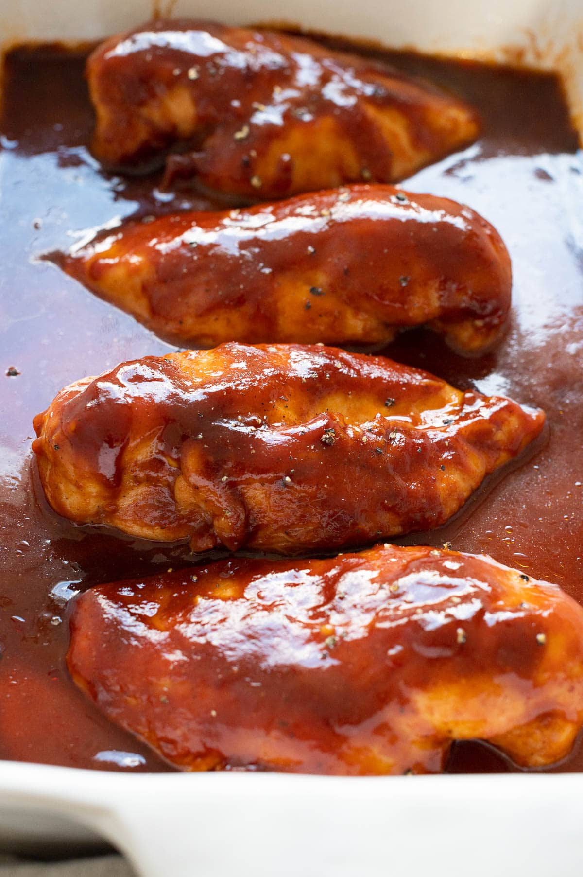 Baked BBQ chicken coated in barbecue sauce.