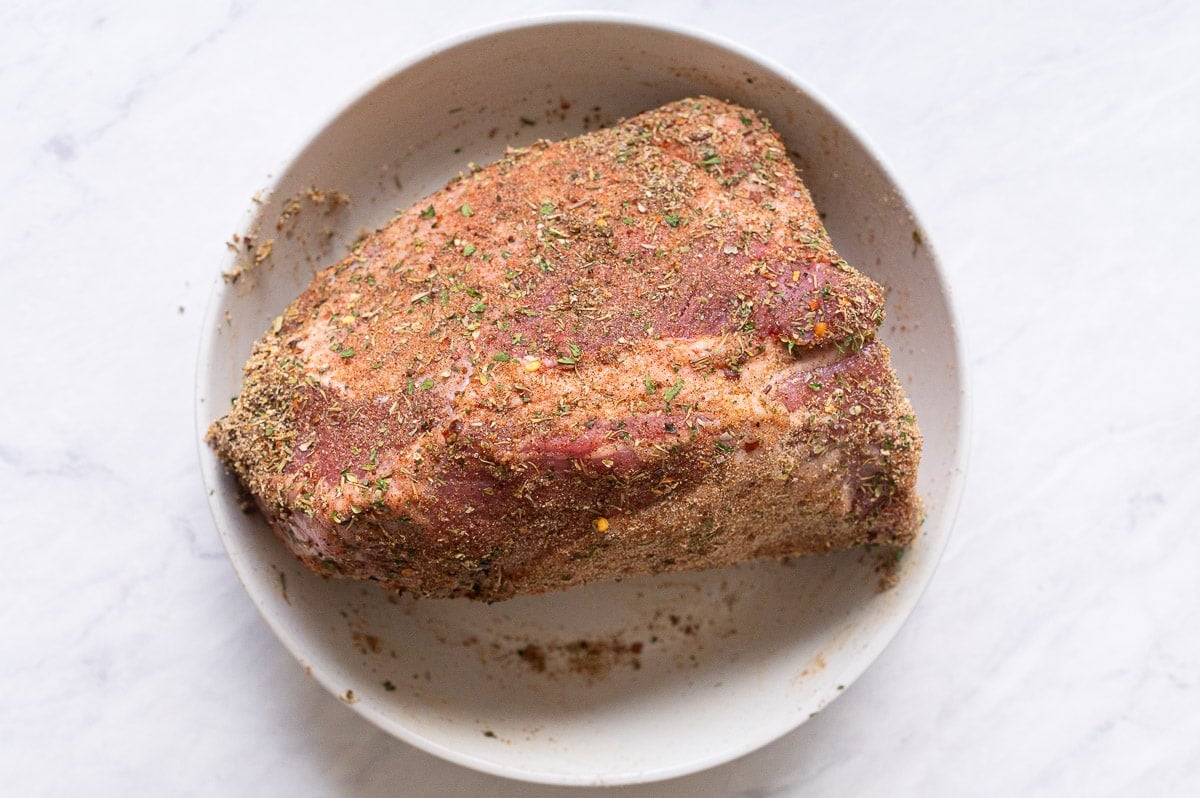 Fresh roast coated in pot roast seasoning on a plate.