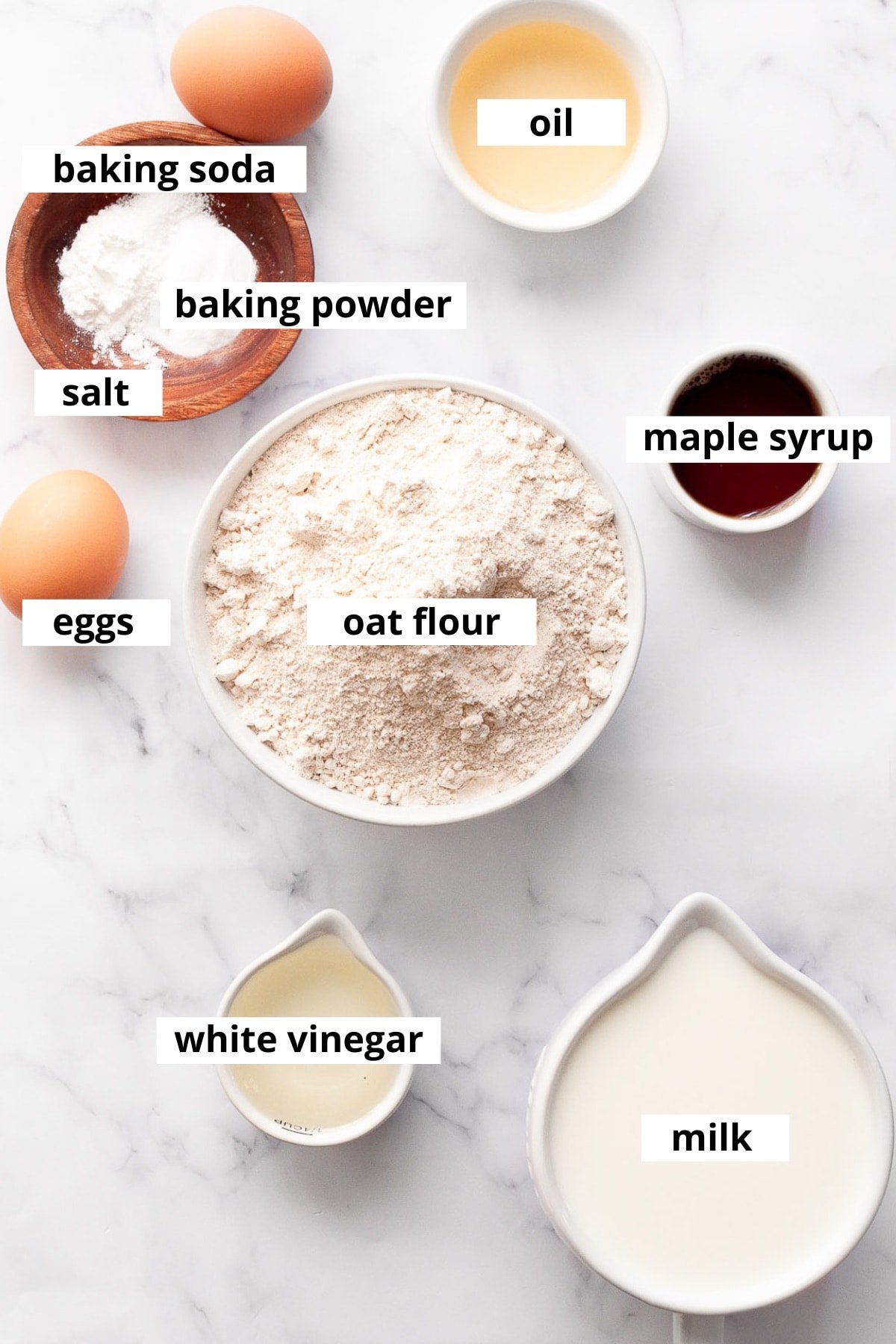 Oat flour, eggs, maple syrup, oil, baking soda, baking powder, salt, white vinegar and milk.