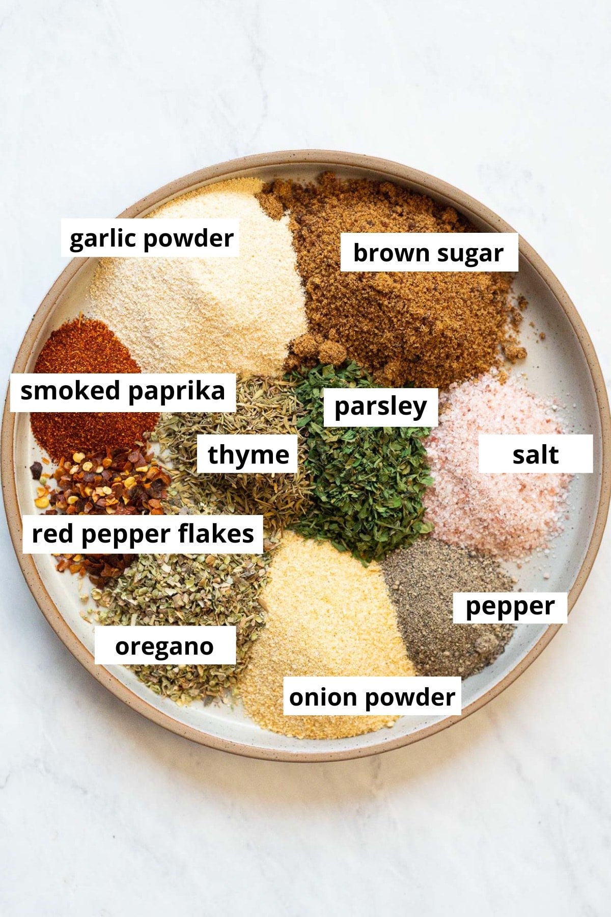 Brown sugar, garlic powder, onion powder, smoked paprika, parsley, oregano, thyme, red pepper flakes, salt, ground black pepper.