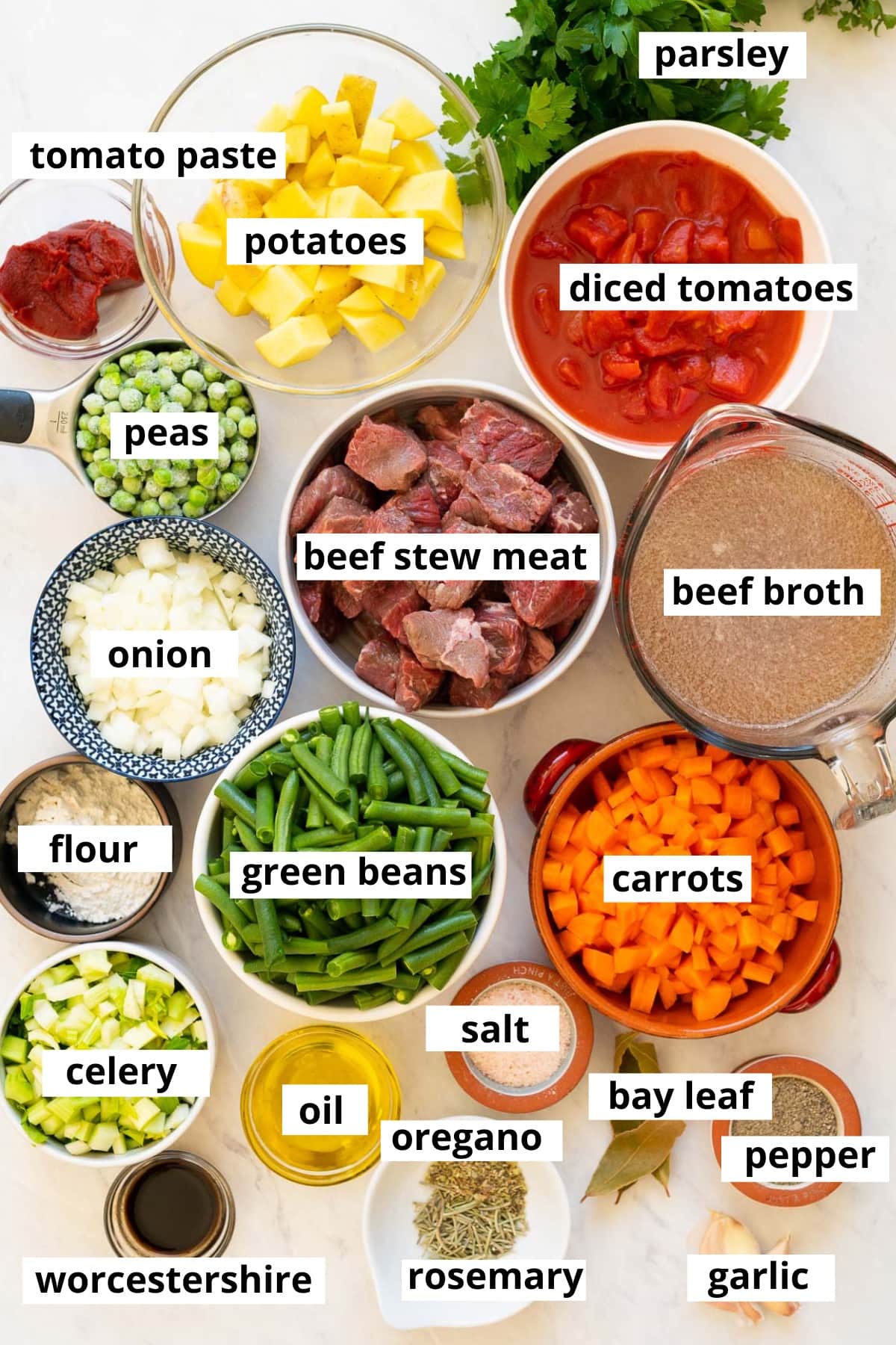 Beef stew meat, green beans, carrots, onion, flour, peas, potatoes, tomatoes, tomato paste, parsley, beef broth, celery, oil, Worcestershire, bay leaf, garlic, spices and oil.