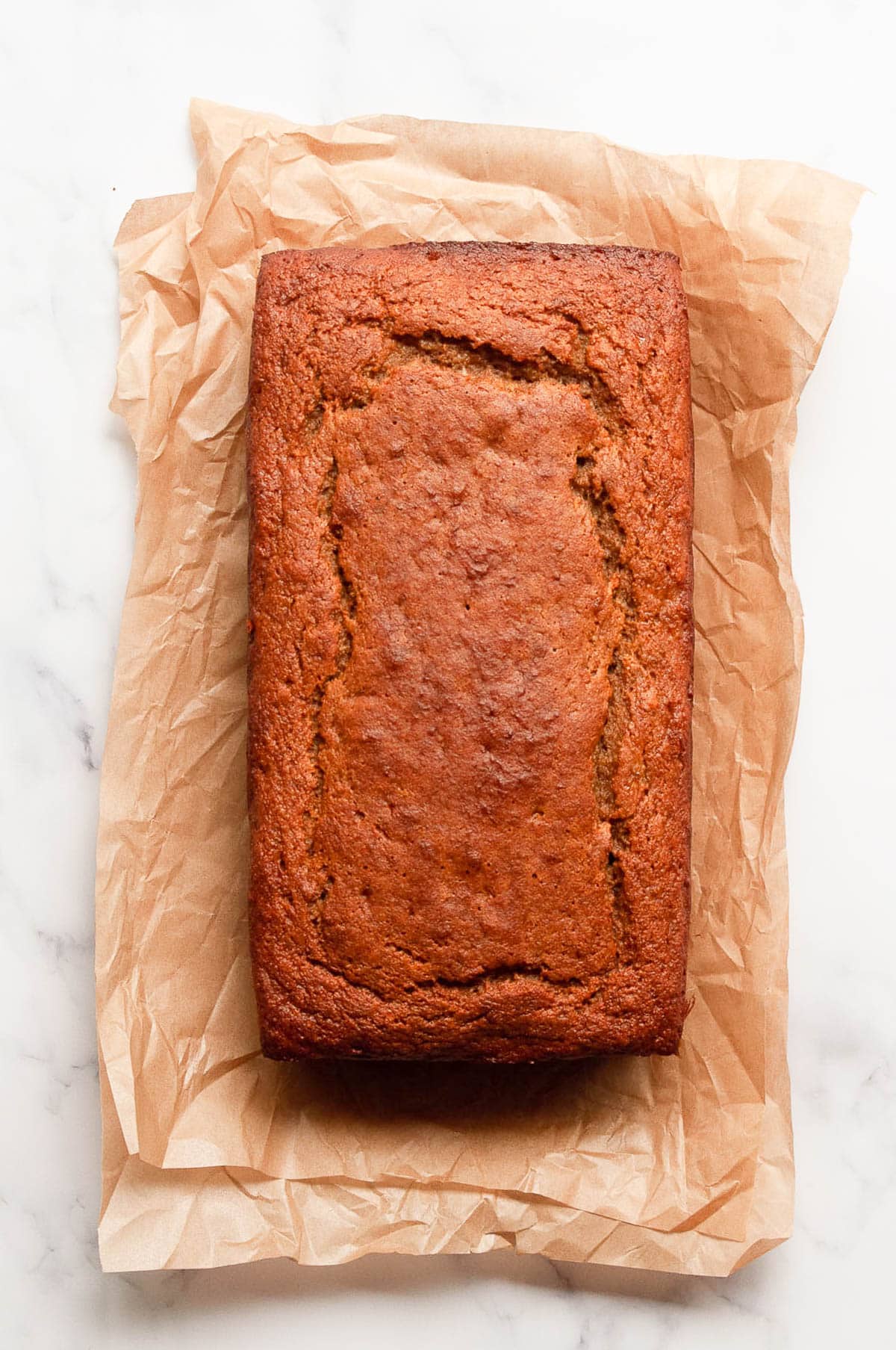 Protein banana bread loaf on parchment paper.