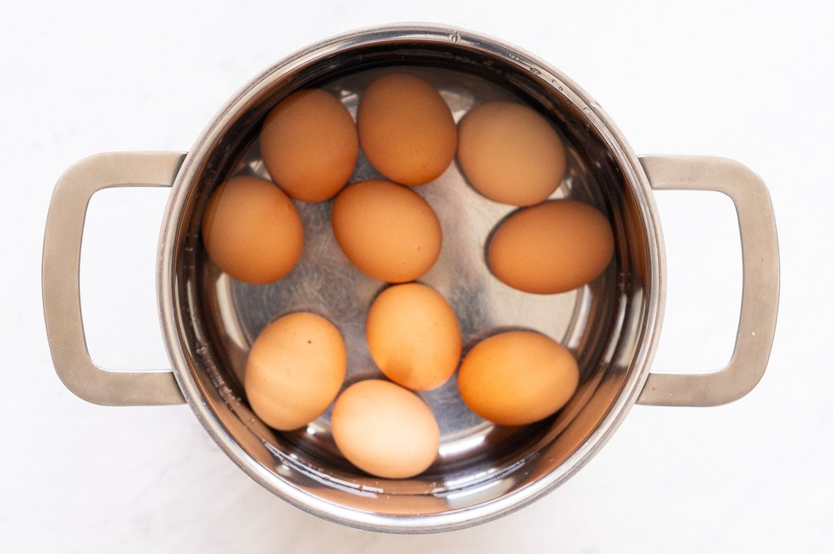 Eggs in a pot with water.