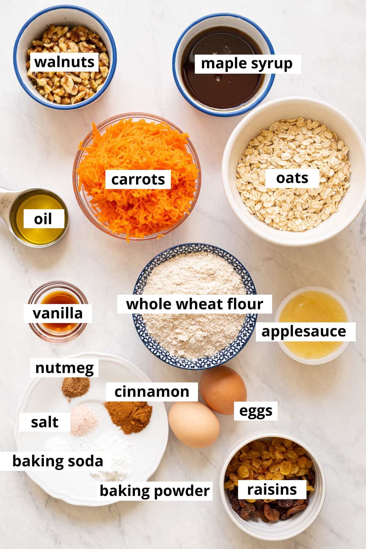 Walnuts, carrots, maple syrup, oats, oil, vanilla, flour, applesauce, eggs, raisins, cinnamon, nutmeg, baking powder, baking soda, salt.