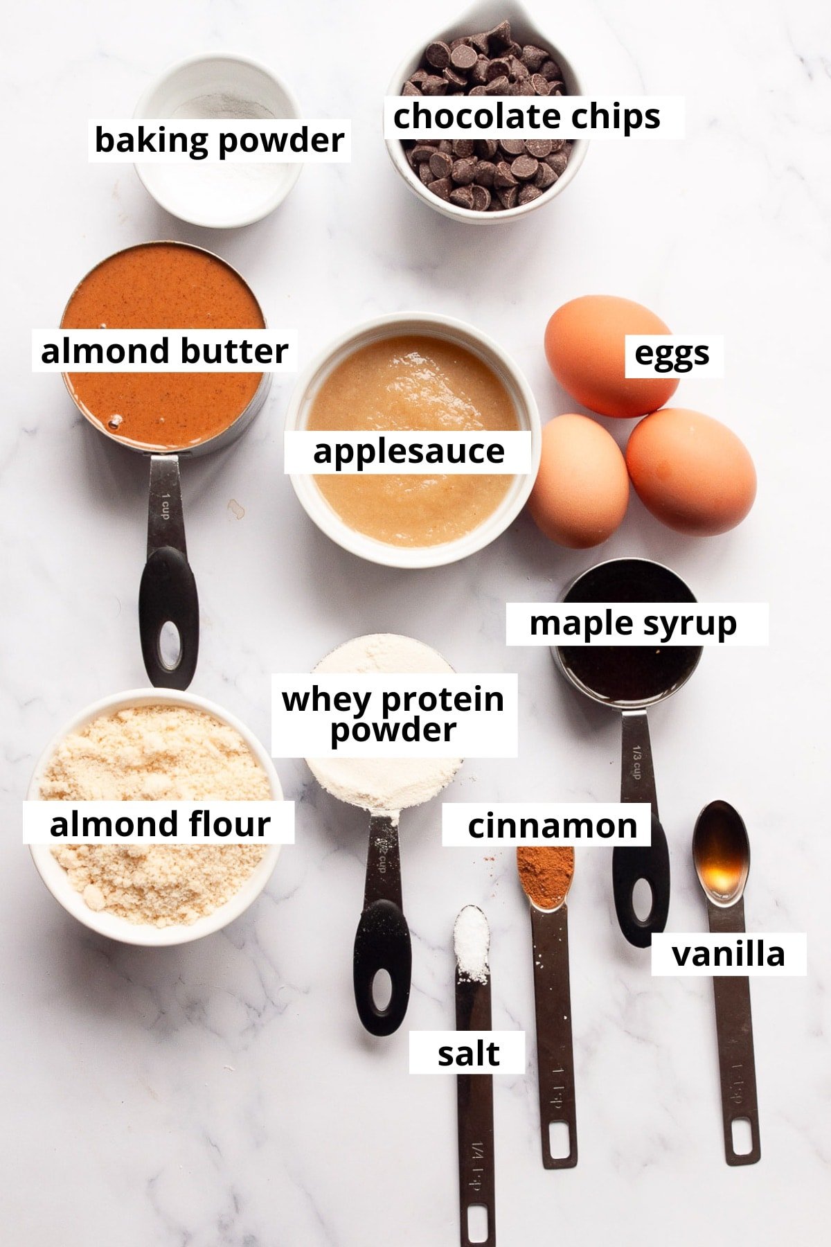 Almond butter, applesauce, chocolate chips, baking powder, eggs, maple syrup, whey protein powder, cinnamon, almond flour, vanilla, salt.