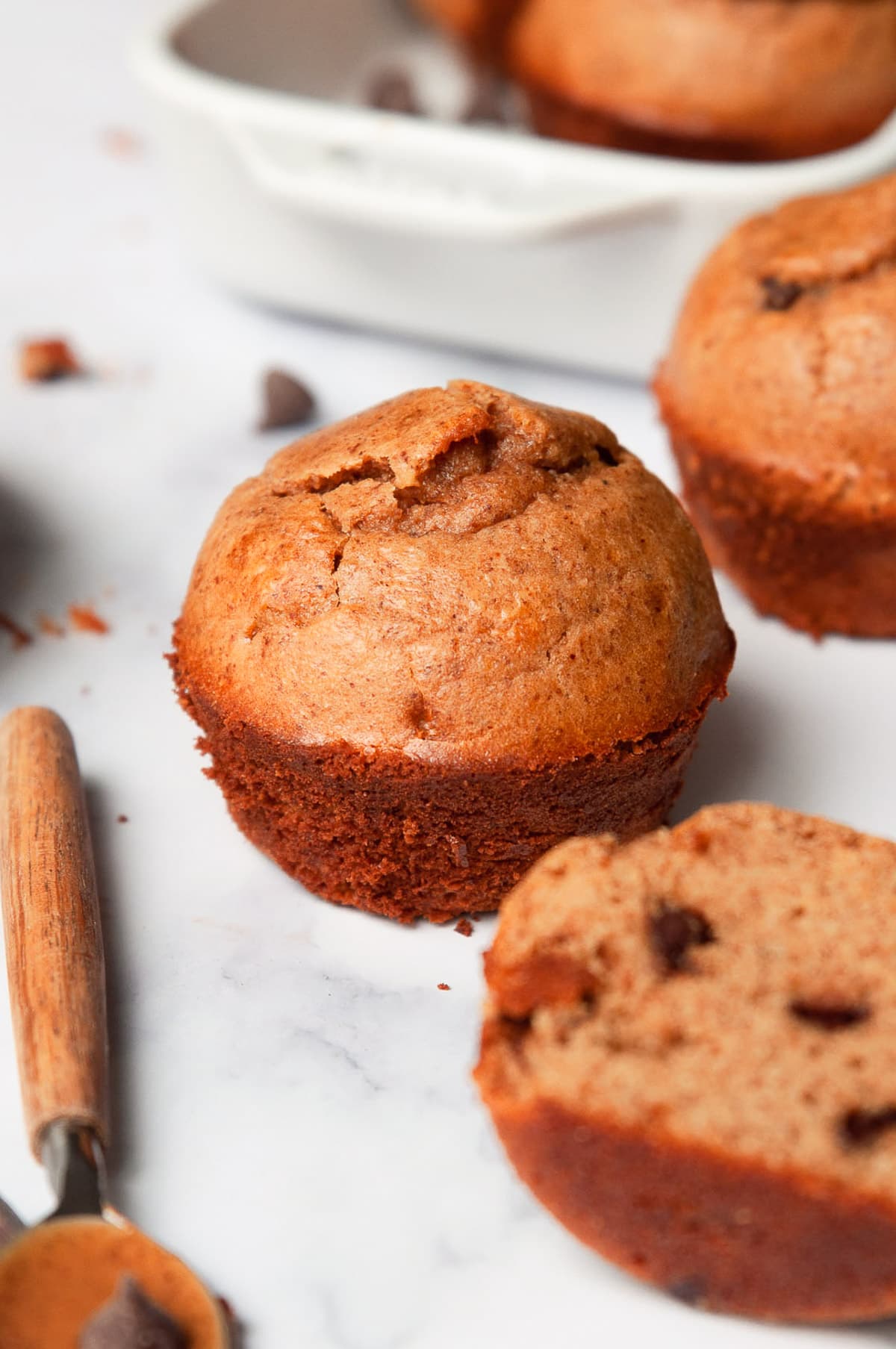 Close up of protein muffin on a counter with a spoonful of nut butter.