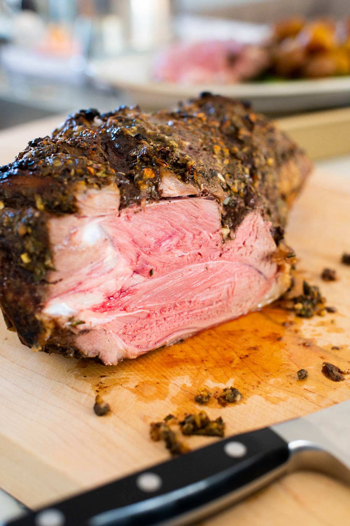 Sliced leg of lamb roast on a cutting board.