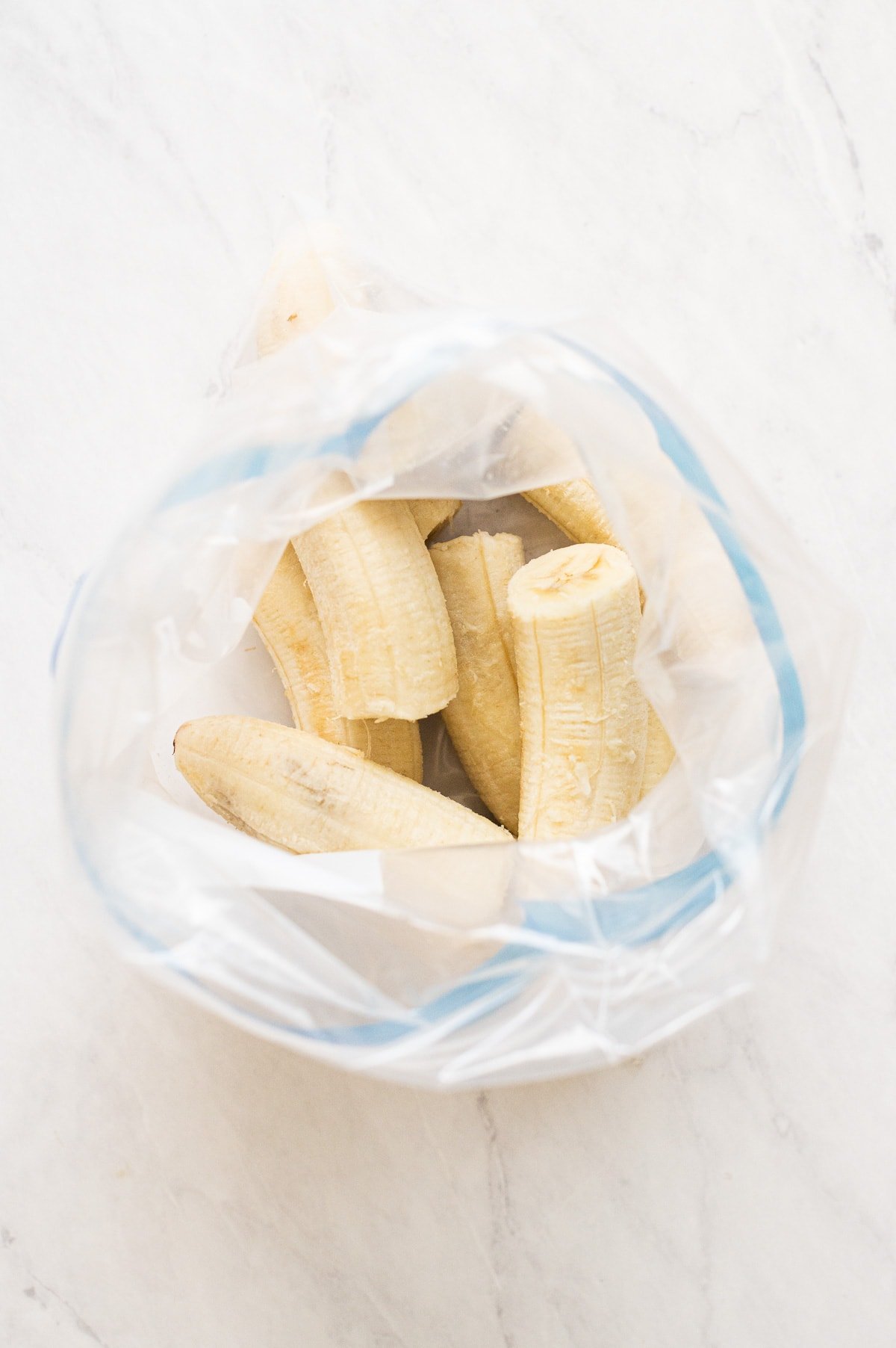Frozen banana halves in a Ziploc bag.