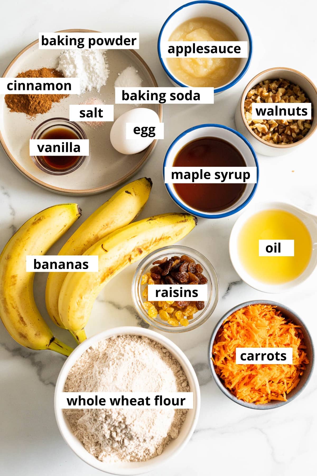 Bananas, shredded carrots, whole wheat flour, raisins, oil, maple syrup, walnuts, applesauce, egg, vanilla, baking soda, baking powder, cinnamon, salt.
