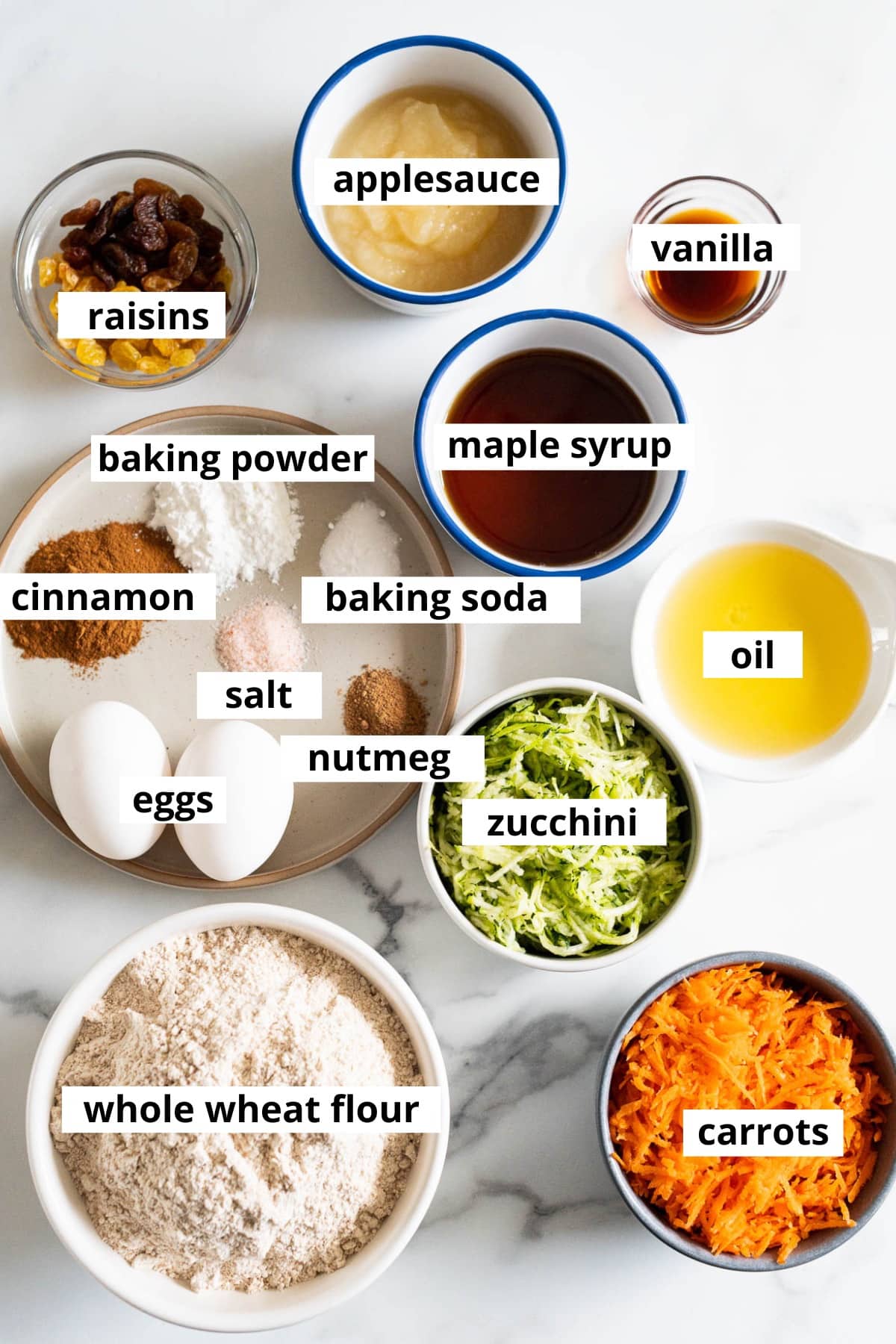 Applesauce, vanilla, raisins, maple syrup, baking powder, baking soda, cinnamon, salt, nutmeg, eggs, zucchini, oil, whole wheat flour, carrots.
