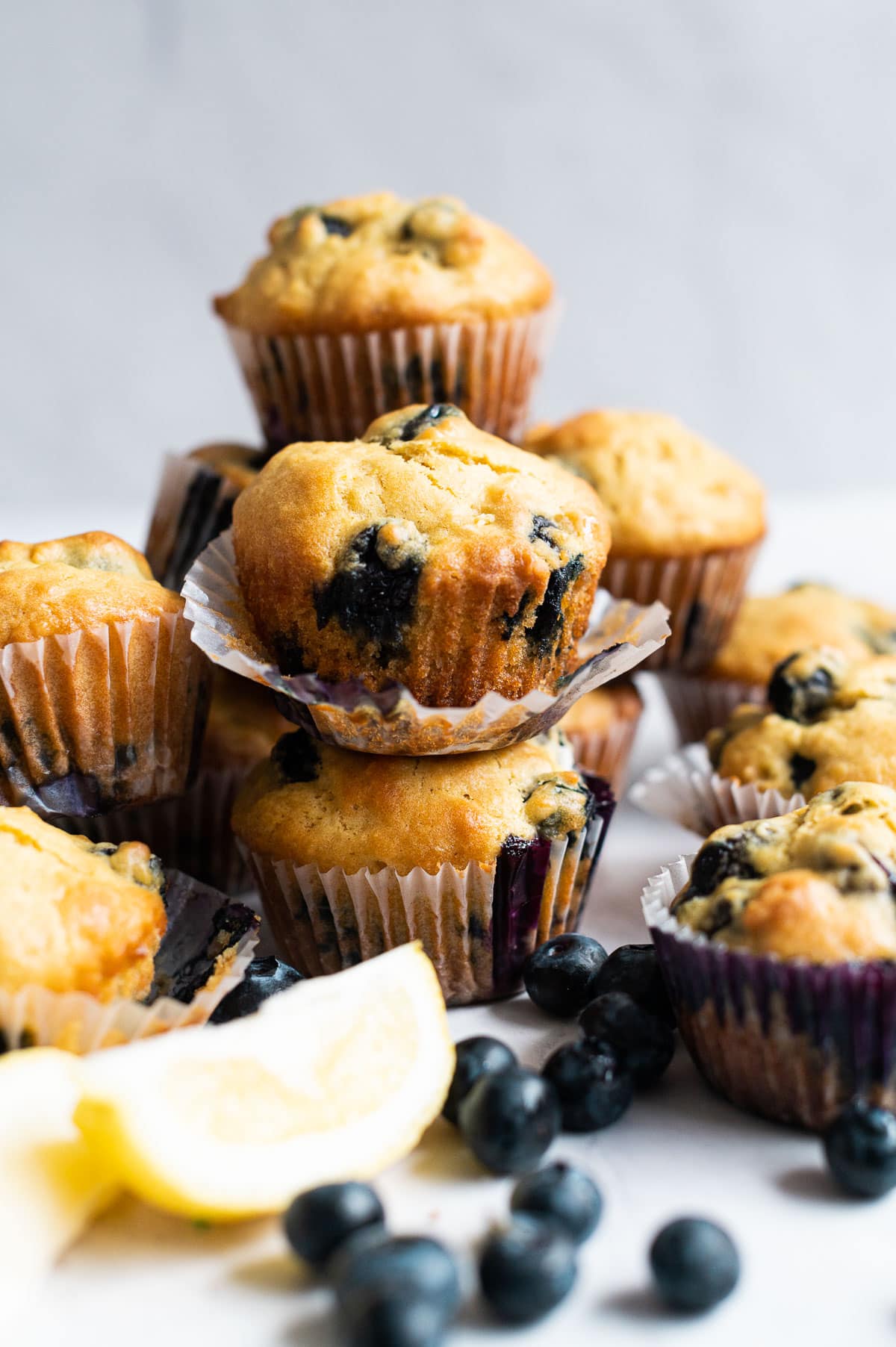 Lemon blueberry muffins stacked on top of which other.