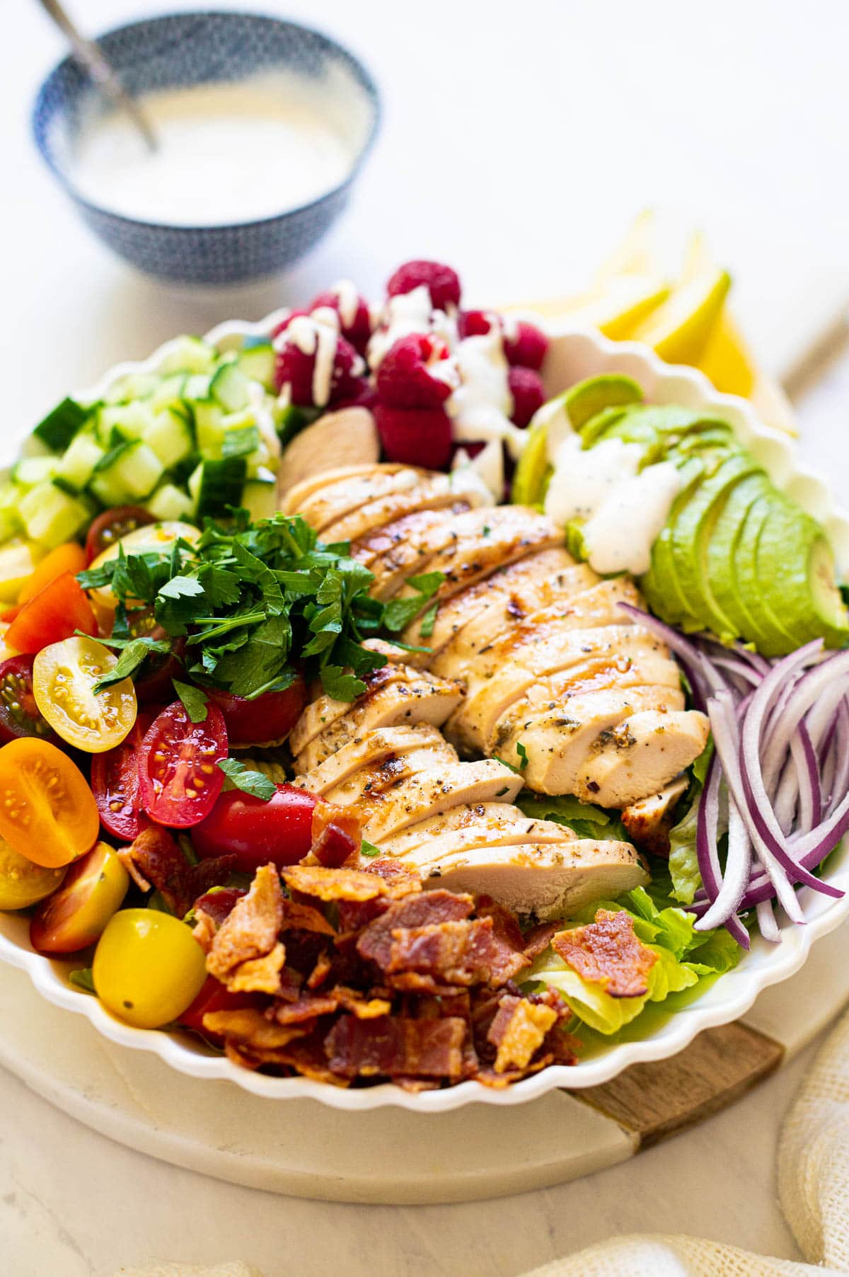 Grilled chicken salad with poppy seed dressing in a bowl.