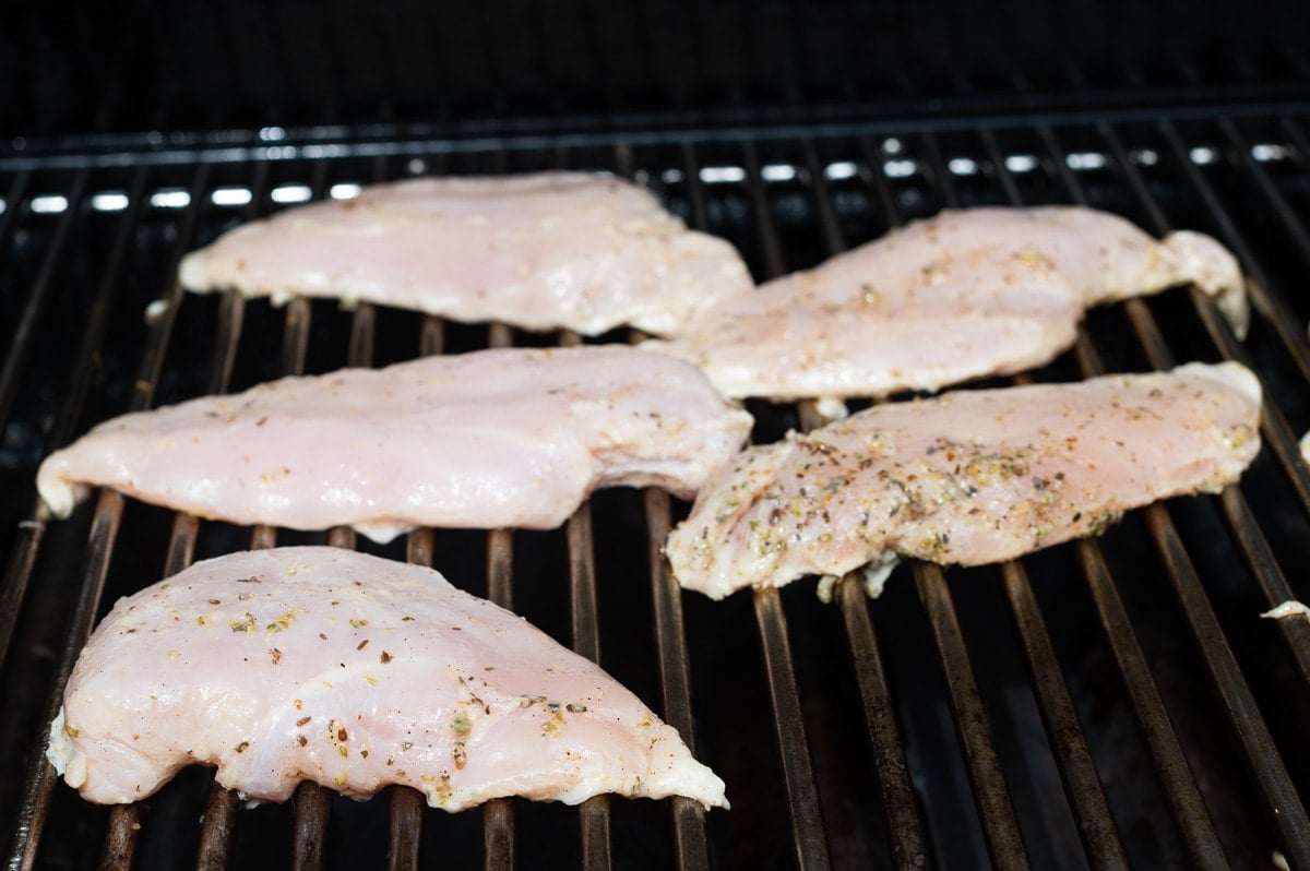 Grilling chicken breasts on BBQ.
