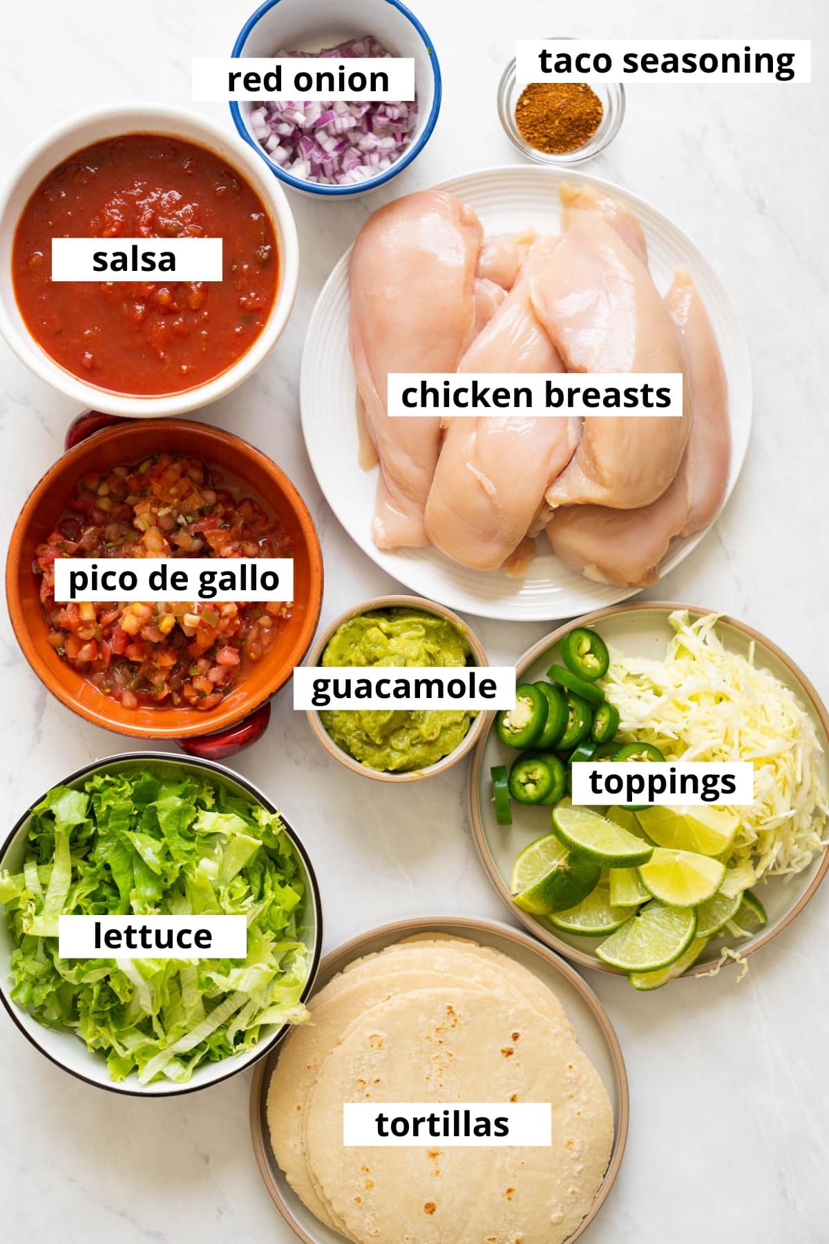 Chicken breasts, salsa, taco seasoning, red onion, pico de gallo, guacamole, lettuce, tortillas, other toppings.