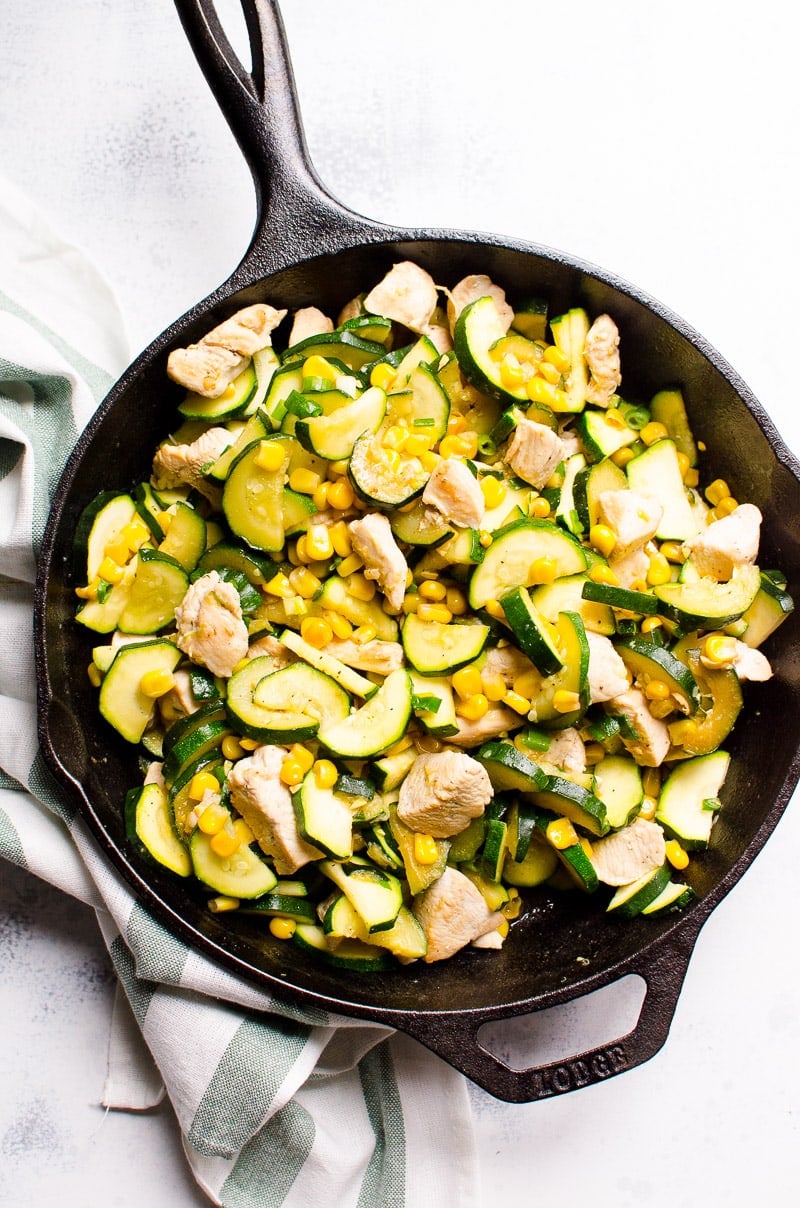 Chicken breast cooked with zucchini, corn and garlic and cast iron skillet.