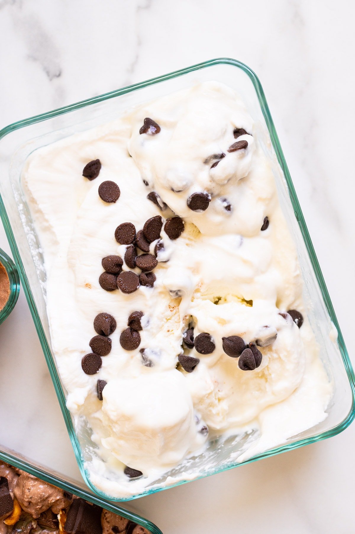 Cottage cheese ice cream recipe with chocolate chips in glass container.