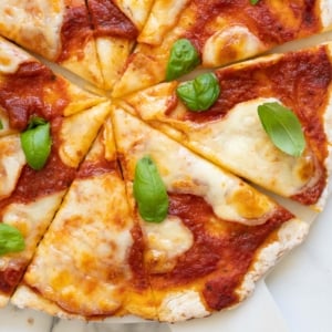 Cottage cheese pizza crust with marinara, melted cheese and fresh basil on top.