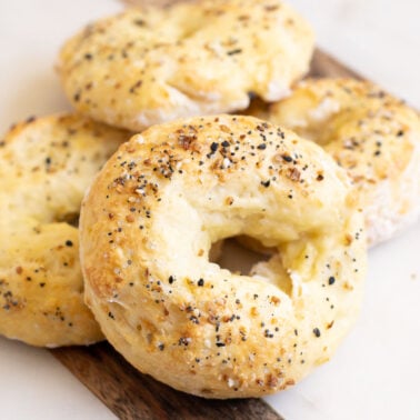 Protein bagels with cottage cheese and everything bagel seasoning on a board.