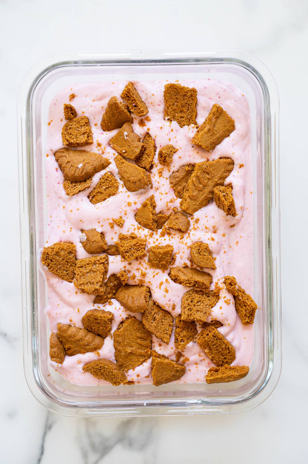 Strawberry cottage cheese ice cream with crushed cookies on top before freezing.