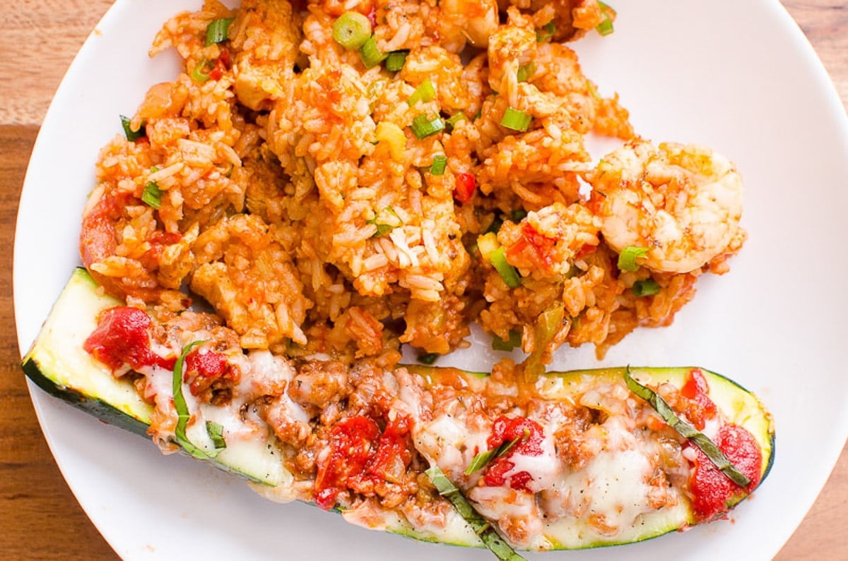 One zucchini boat served with Instant Pot Jambalaya on white plate.