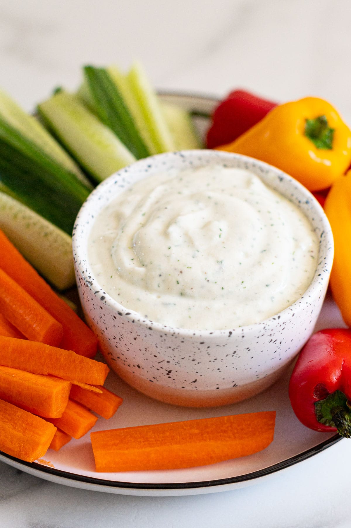 Cottage cheese ranch dip served with vegetables on a platter.