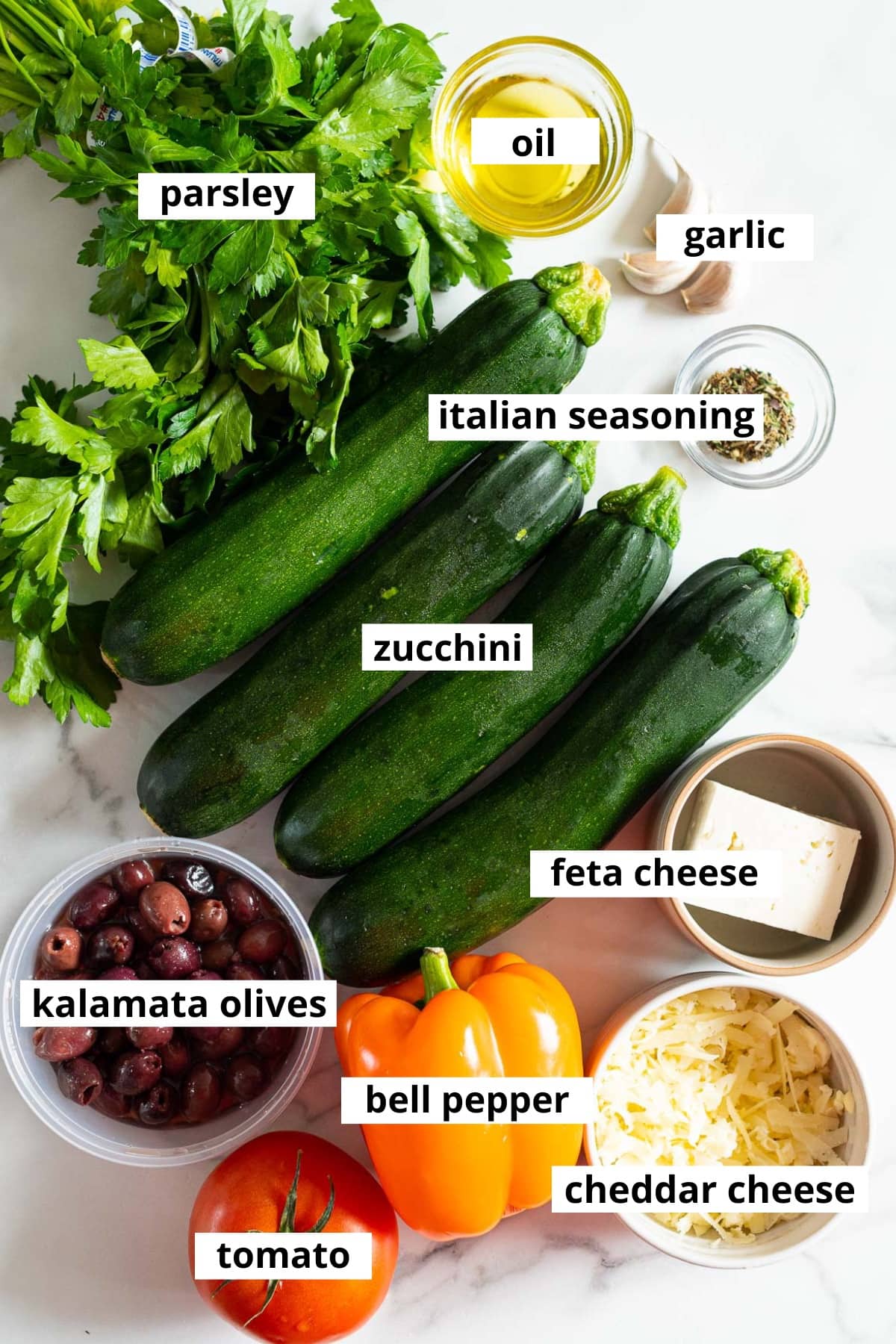Zucchini, parsley, garlic, oil, Italian seasoning, feta cheese olives, bell pepper, tomato, cheddar cheese.