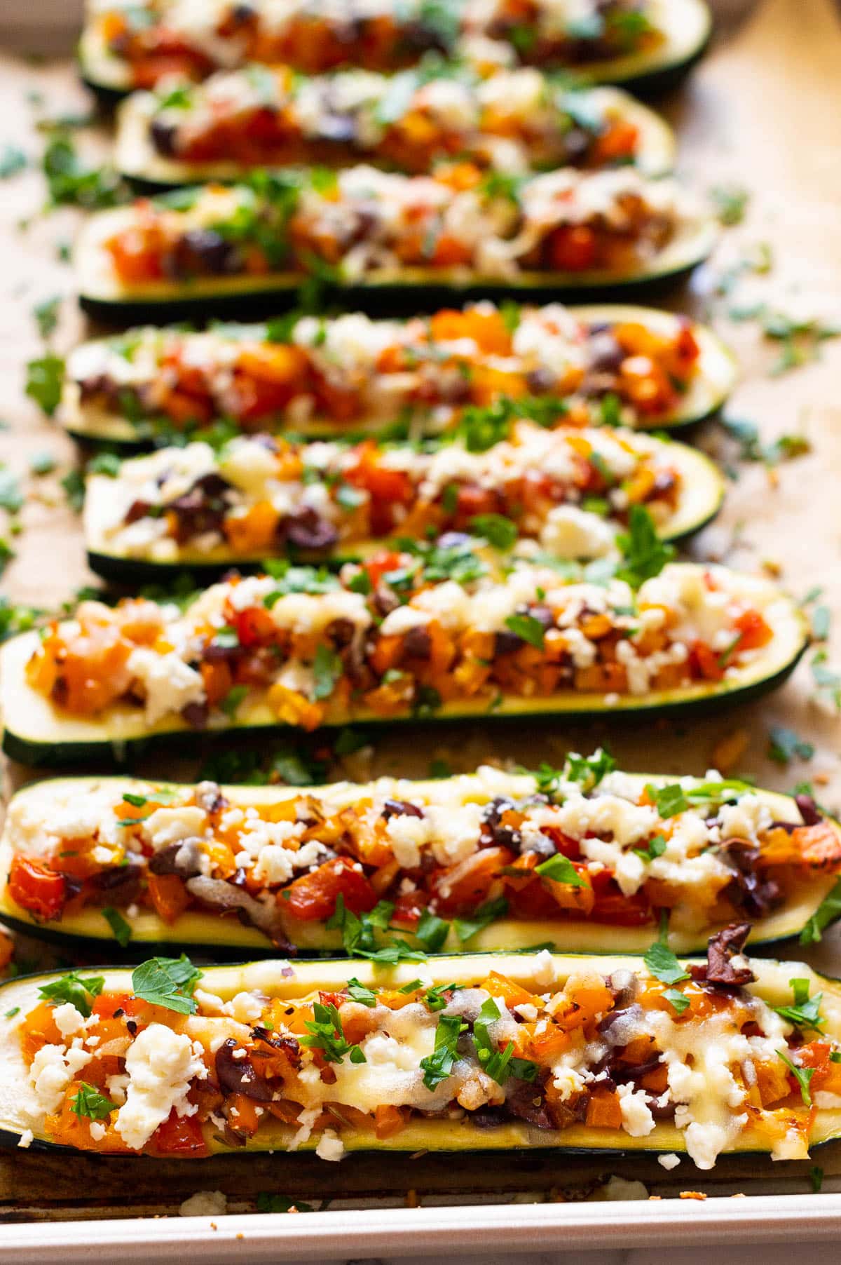 Side view of stuffed zucchini boats with Mediterranean filling.