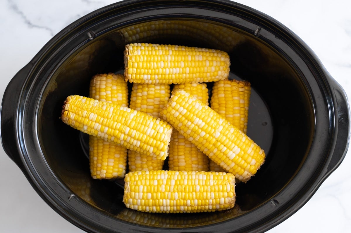 Cooked corn on the cob in a slow cooker.