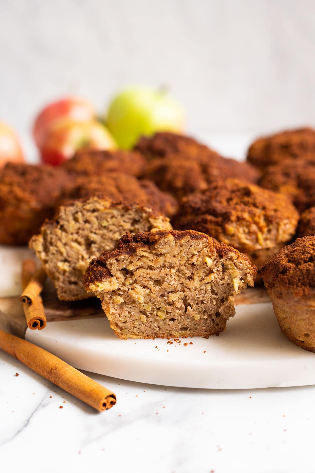 Close up of cinnamon apple muffin cut in half and showing texture inside.