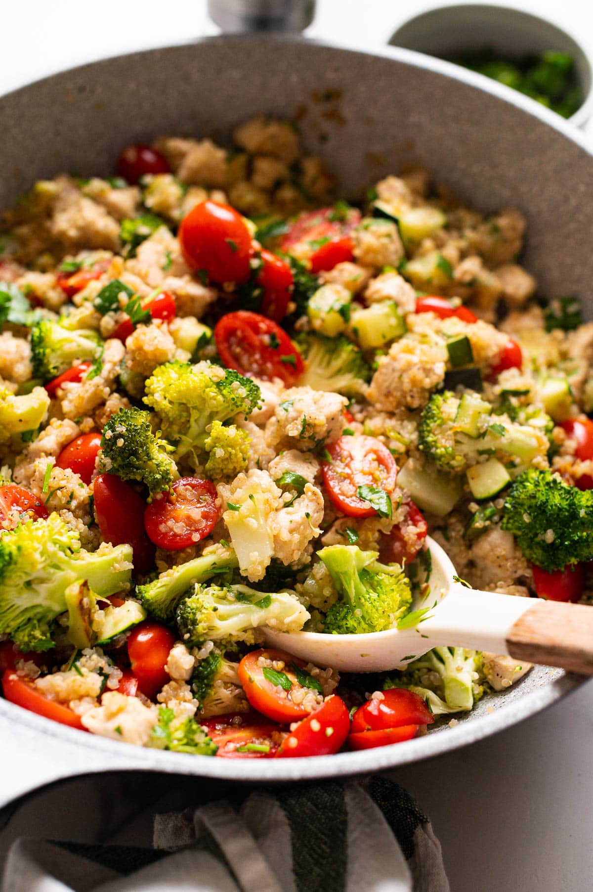 Side view of chicken quinoa dish in a skillet.