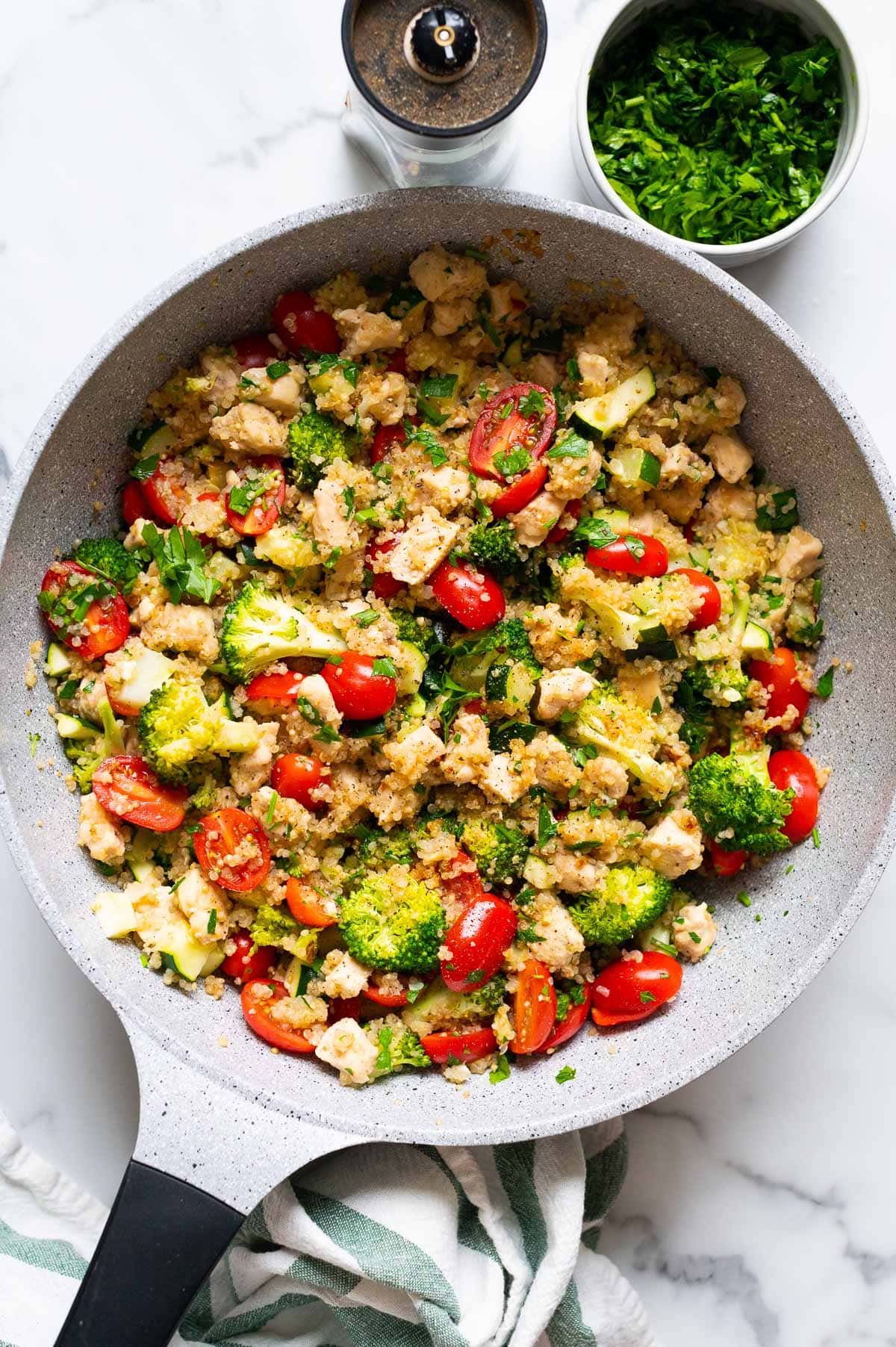 Chicken quinoa skillet with zucchini, broccoli and grape tomatoes.