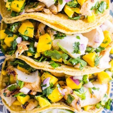 Grilled fish tacos with mango salsa and cilantro.
