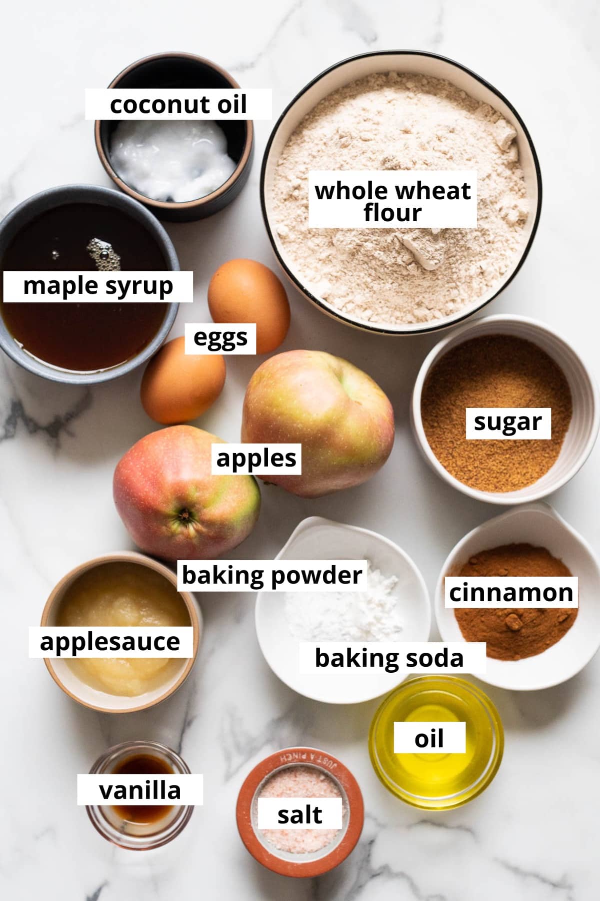 Whole wheat flour, maple syrup, eggs, coconut oil, apples, sugar, applesauce, cinnamon baking powder, baking soda, oil, vanilla, salt.