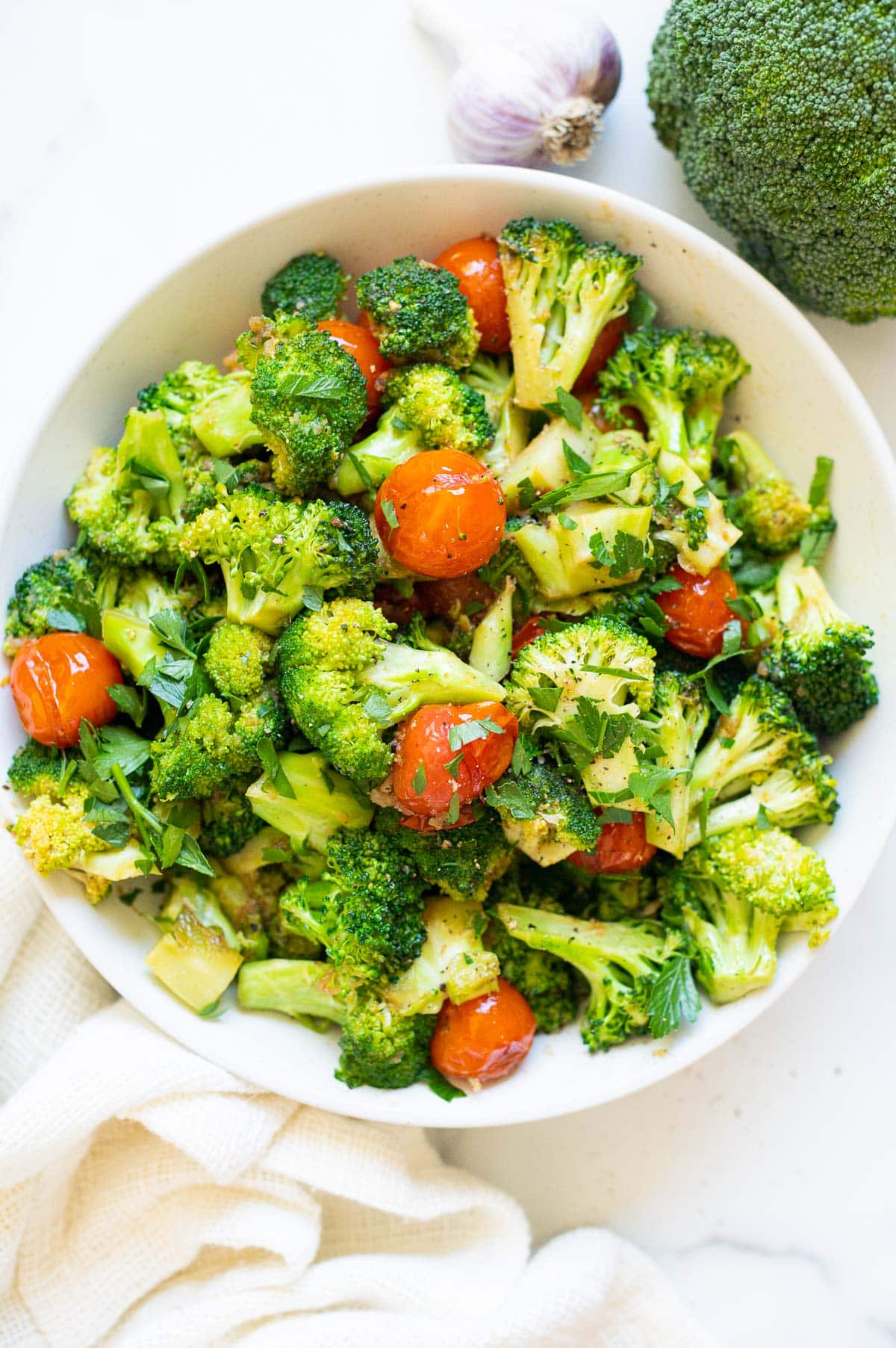 Sauteed broccoli recipe garnished with parsley in a bowl.