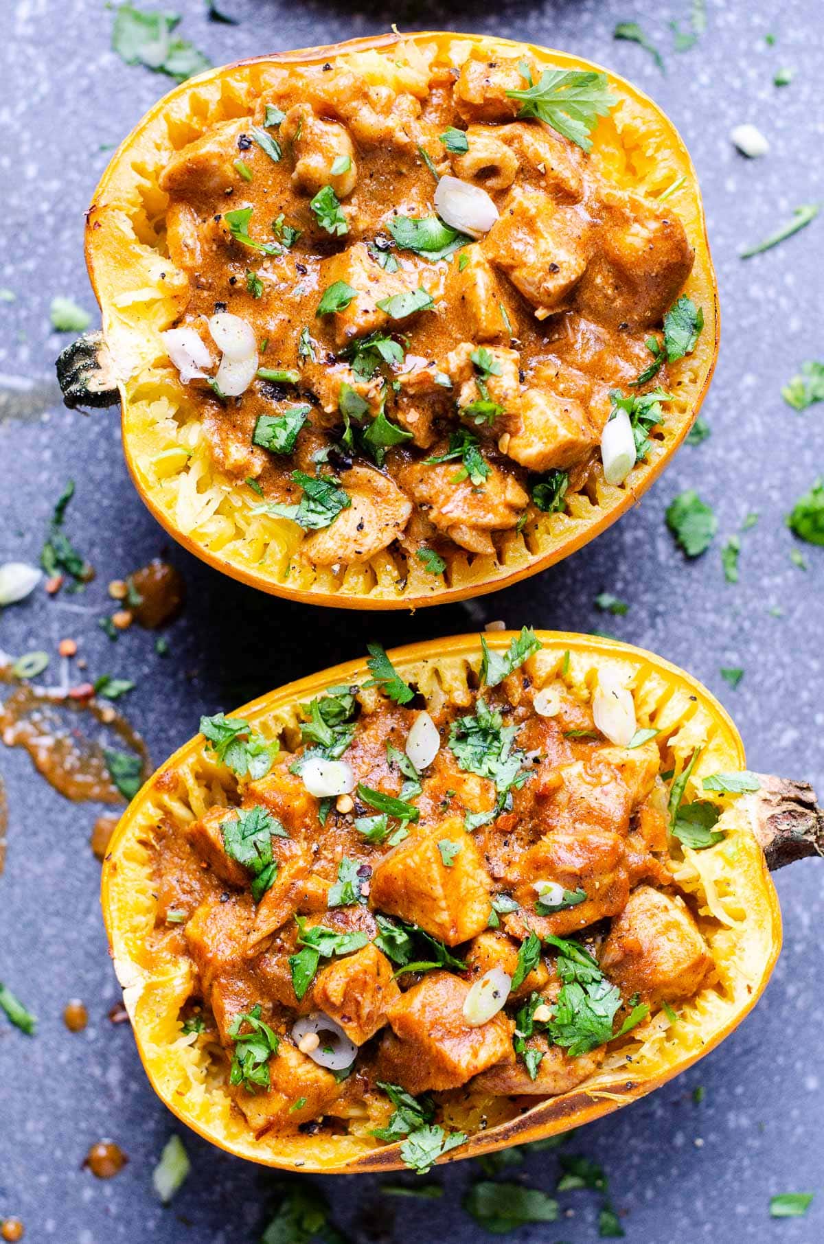 Butter chicken spaghetti squash garnished with cilantro and green onions.