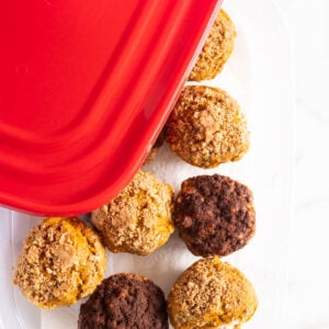 Muffins in a plastic container with a lid.