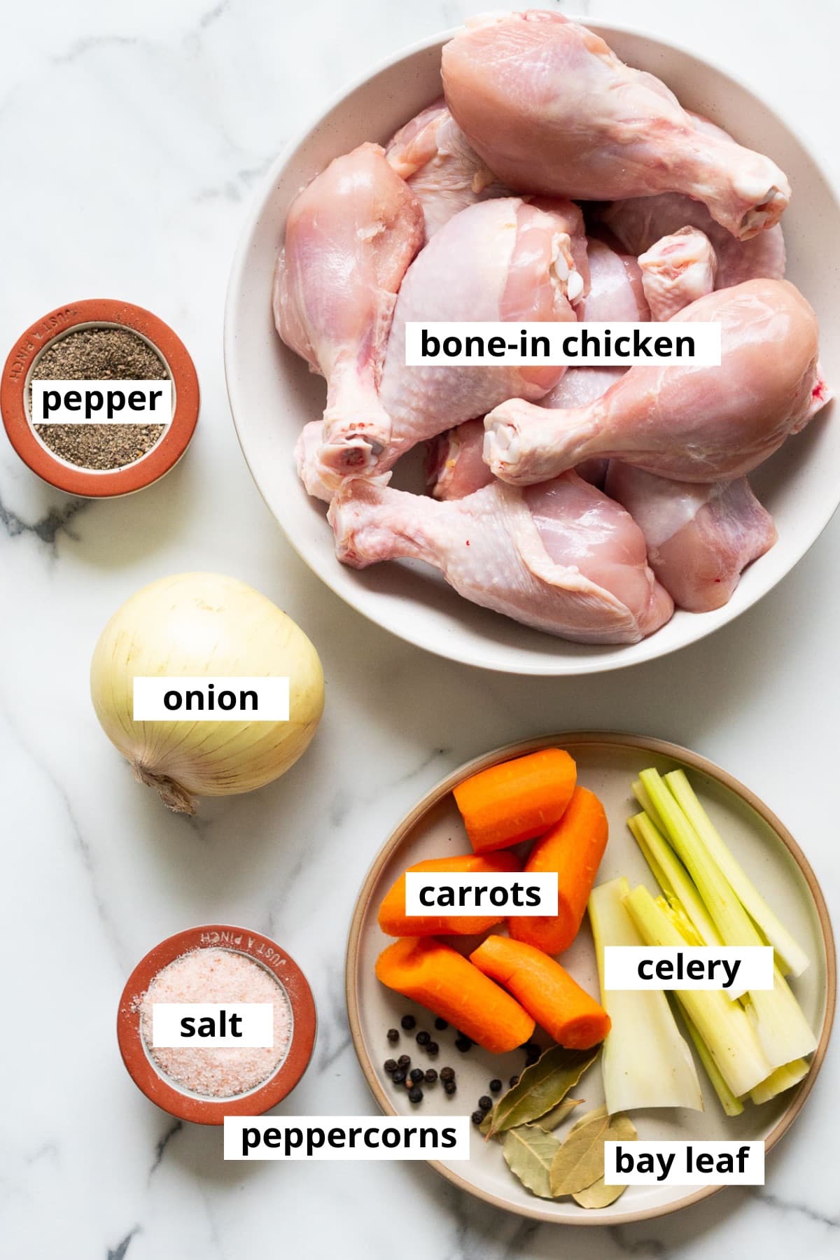 Chicken drumsticks, onion, carrots, celery, bay leaves, peppercorns, salt and pepper.
