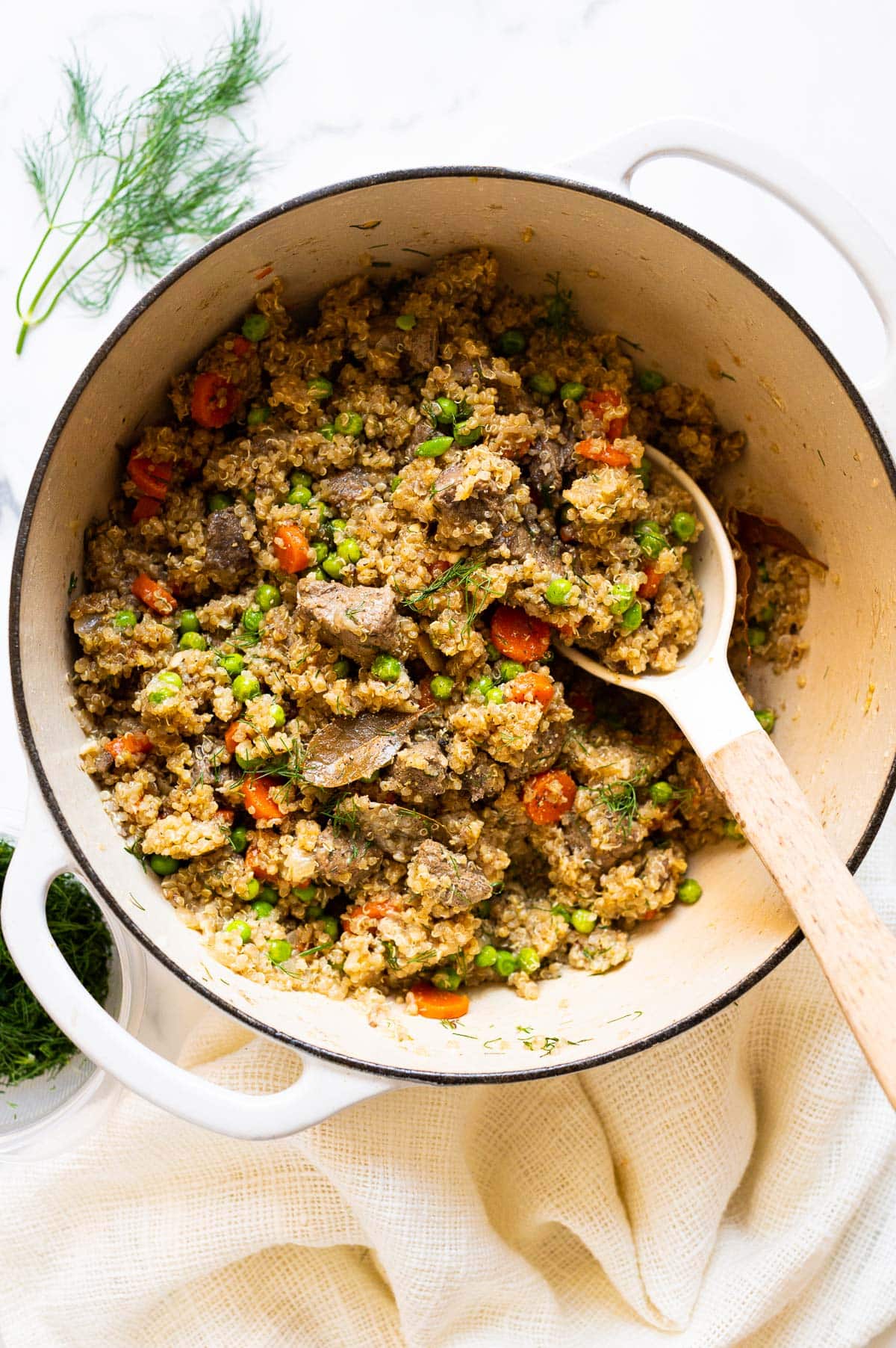 Beef quinoa stew in a pot with spoon.